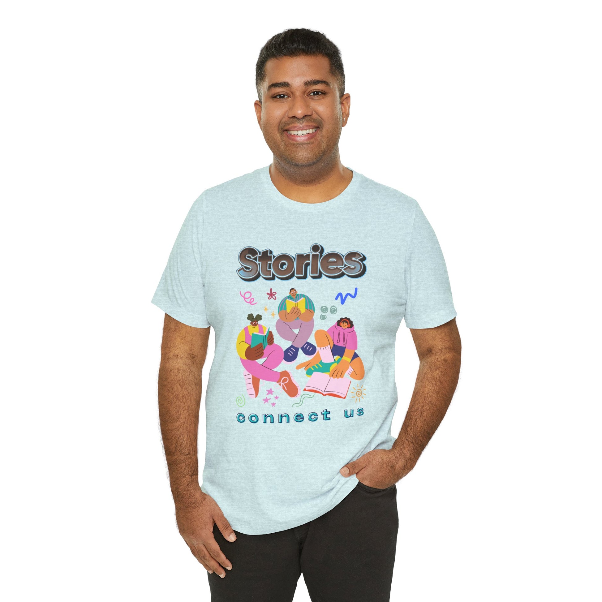 Man wearing a light ice blue t-shirt with colorful modern people reading, surrounded by doodles, and text 'Stories connect us' 