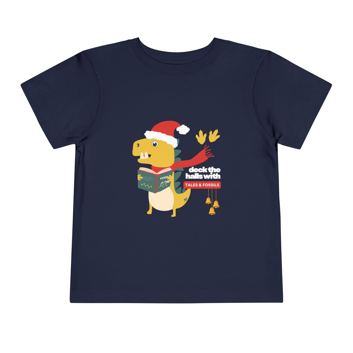 Navy toddler t-shirt with a Christmas-themed dinosaur graphic reading or singing from a book, and text 'deck the halls with tales & fossils' on a white background