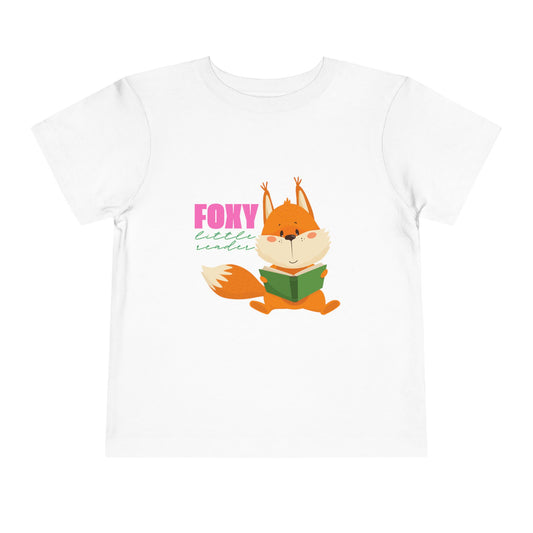 White toddler t-shirt with a fox reading a book graphic and 'Foxy Little Reader' text 