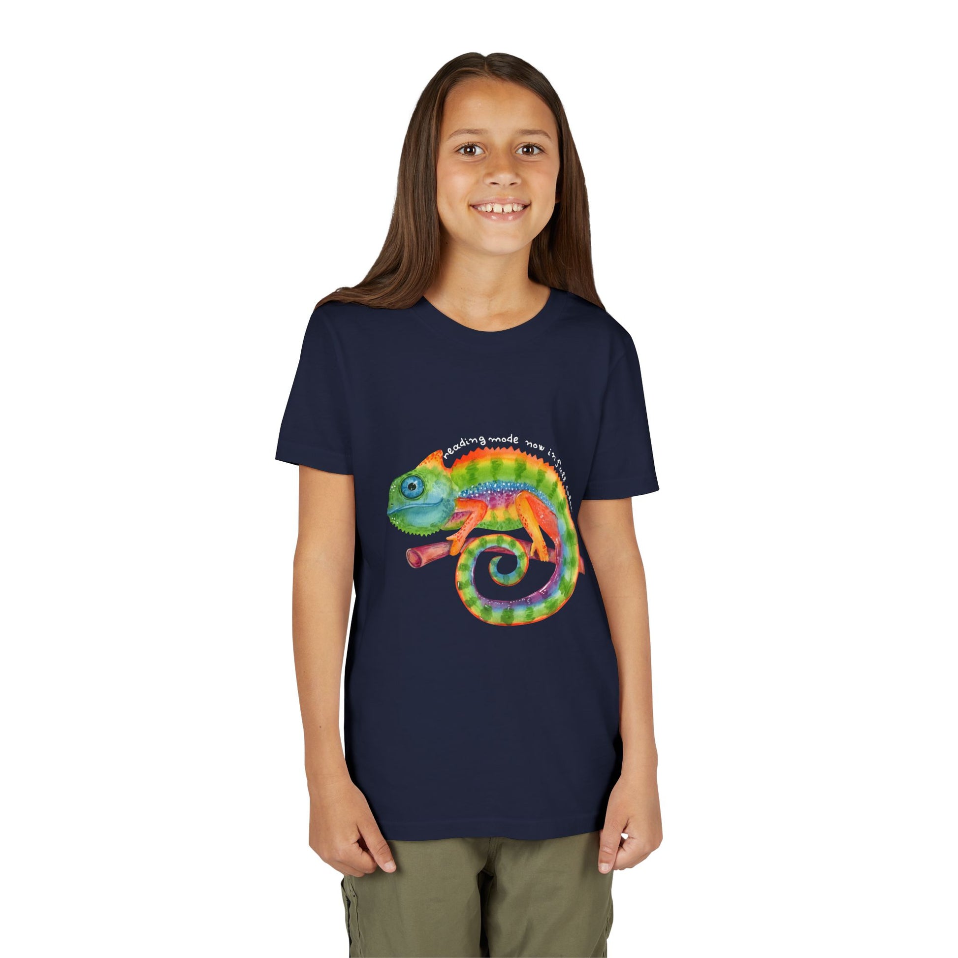 Girl wearing a navy blue t-shirt with a colorful chameleon and text 'reading mode now in full color'