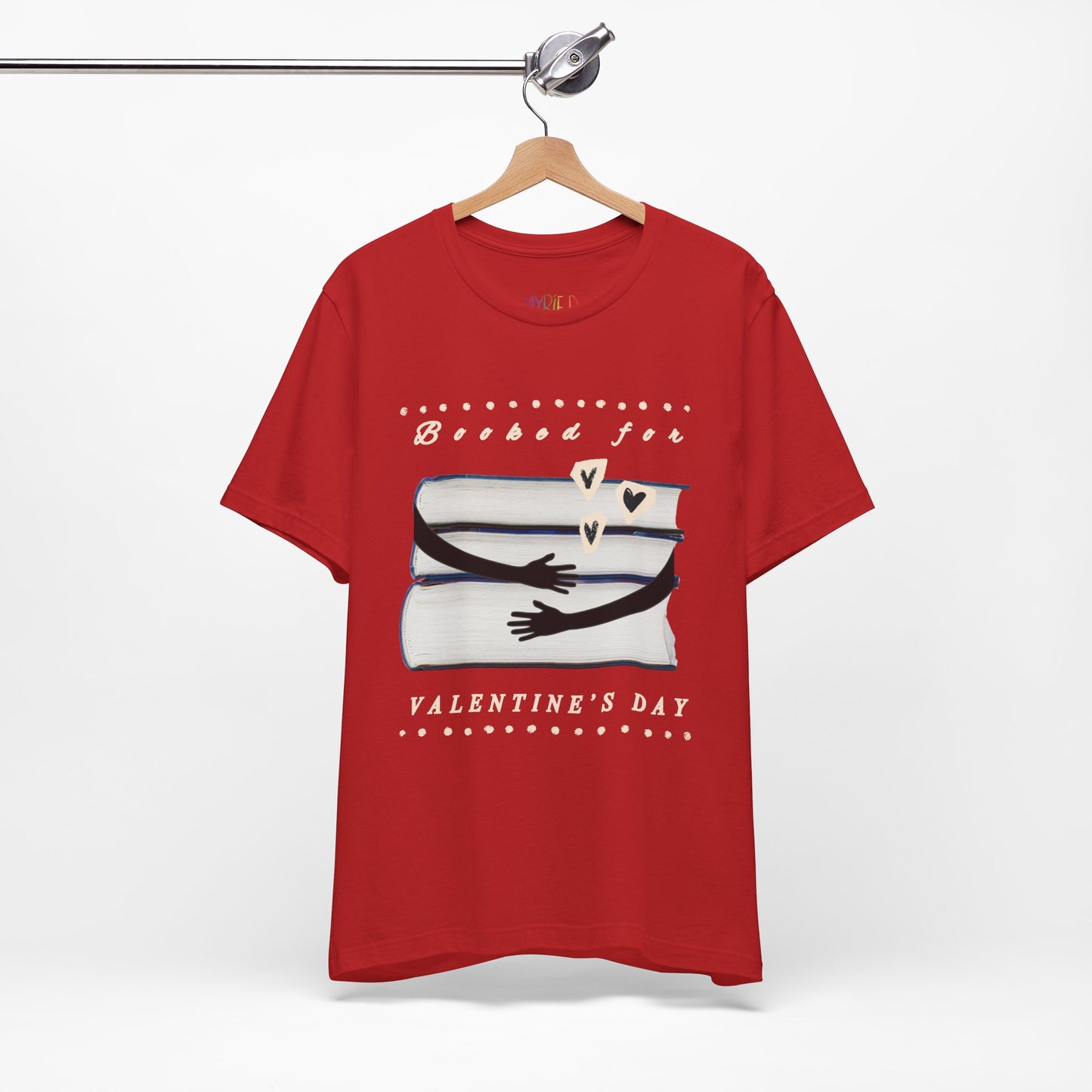 Red t-shirt with a graphic design featuring arms hugging a stack of books and text 'Booked for Valentine's Day' 