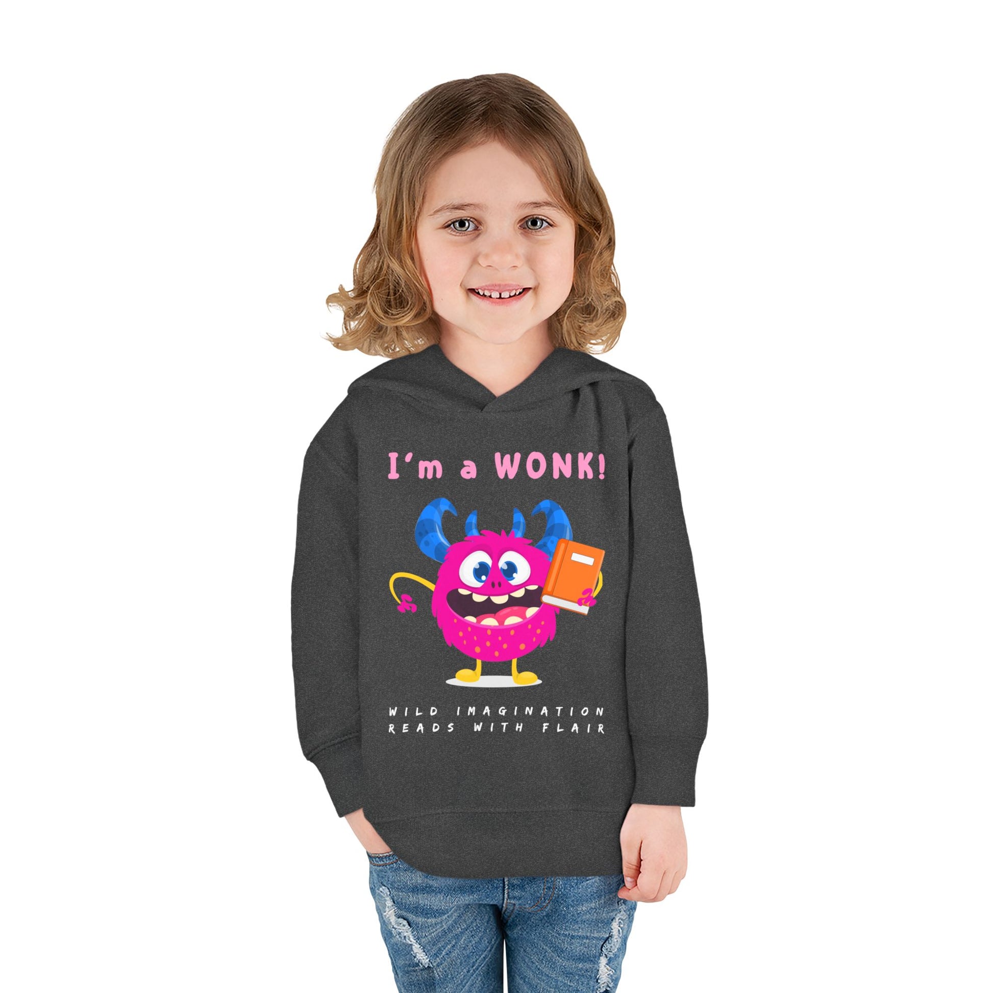 Girl wearing a dark gray toddler hoodie with a cartoon monster holding a book and text 'I'm a Wonk!'