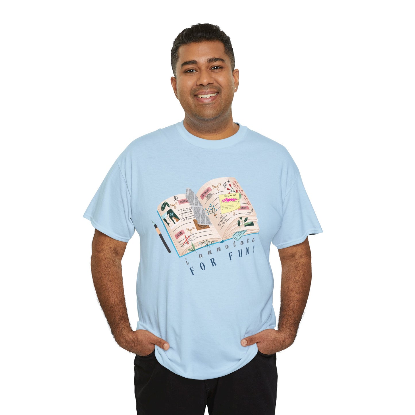 Man wearing a light blue t-shirt with a An open scrapbook full of scribbles, tickets, newspaper clippings and more, text 'I Annotate For Fun' 