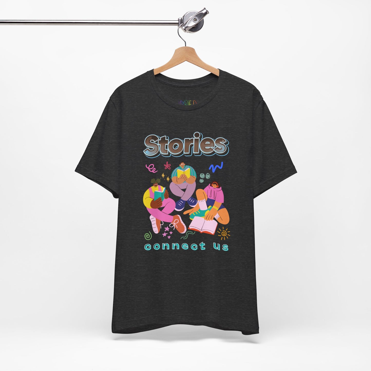Dark gray t-shirt with colorful modern people reading, surrounded by doodles, and text 'Stories connect us' 
