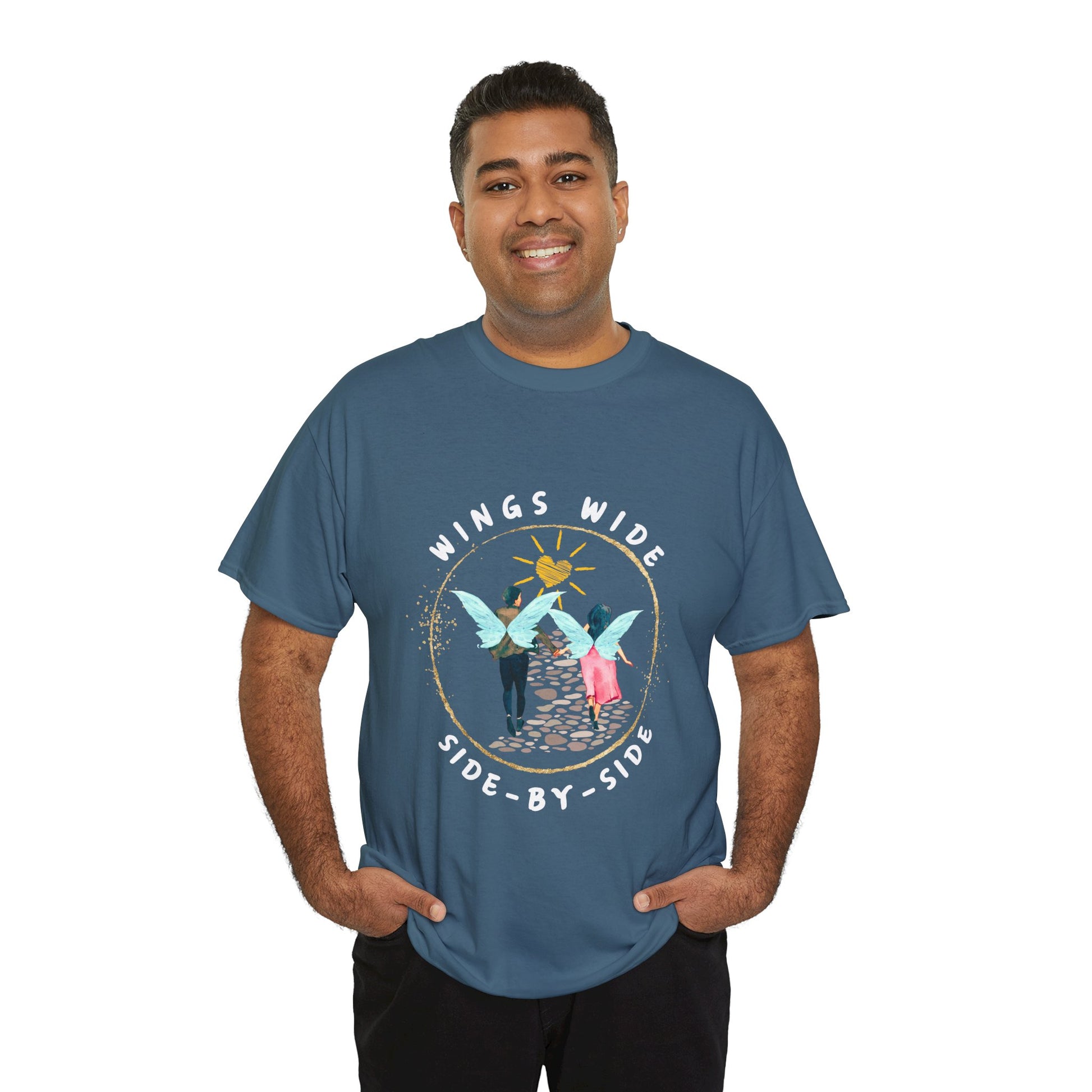 Man wearing a teal t-shirt with a fairy couple running off into the sunset down a cobblestone path and text 'Wings Wide Side-By-Side'