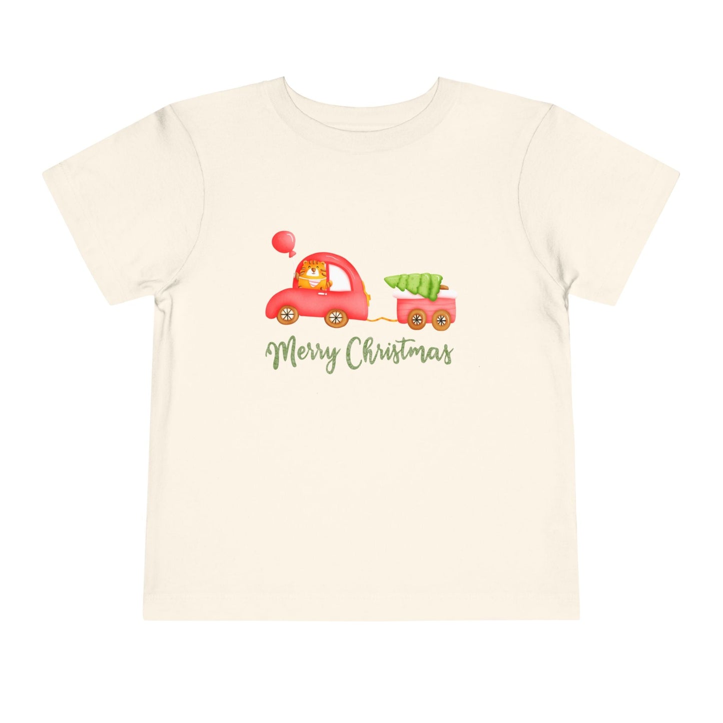 Beige toddler t-shirt with a tiger driving a red car, pulling a tailer with a Christmas tree and text 'Merry Christmas' on a white background