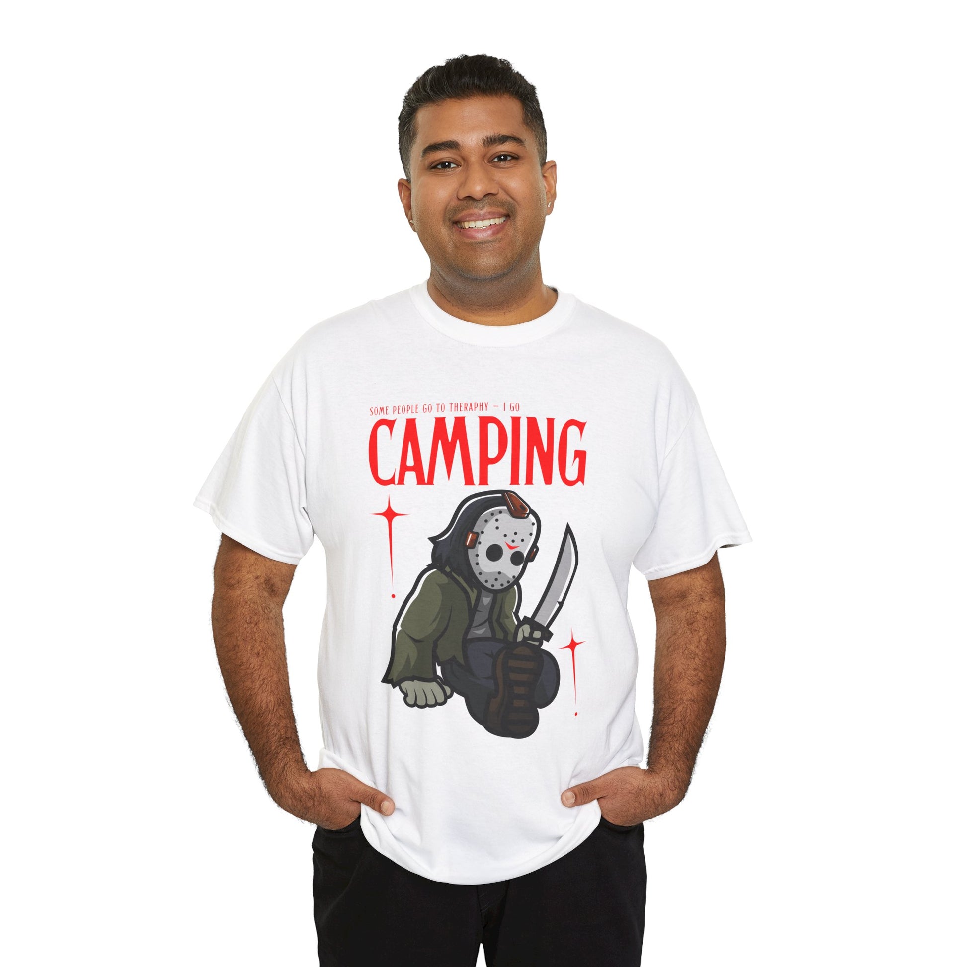 Man wearing a white t-shirt with a graphic design of a Jason character holding a knife and text 'Some People Go to Therapy...I Go CAMPING' on a hanger against a white background.