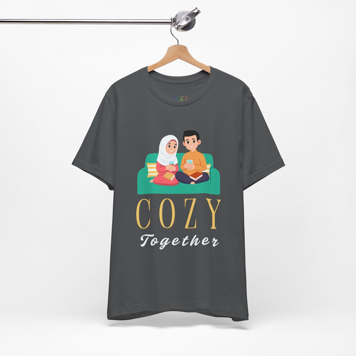 Gray t-shirt with a graphic of two people on a couch, with books and drinks, the text 'Cozy Together' sits beneath in large letters