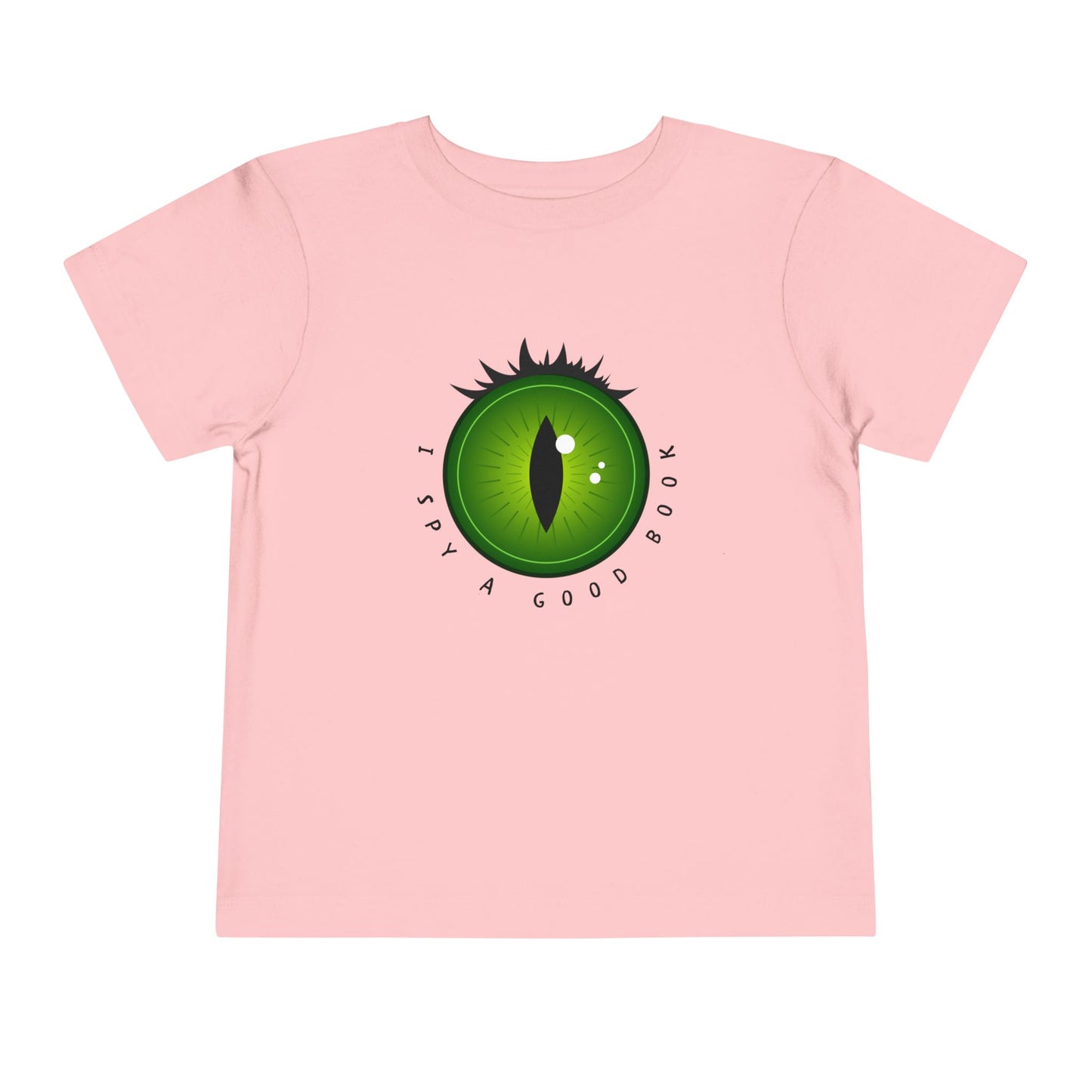 Pink t-shirt with a green dragon eye design and text 'I SPY A GOOD BOOK'