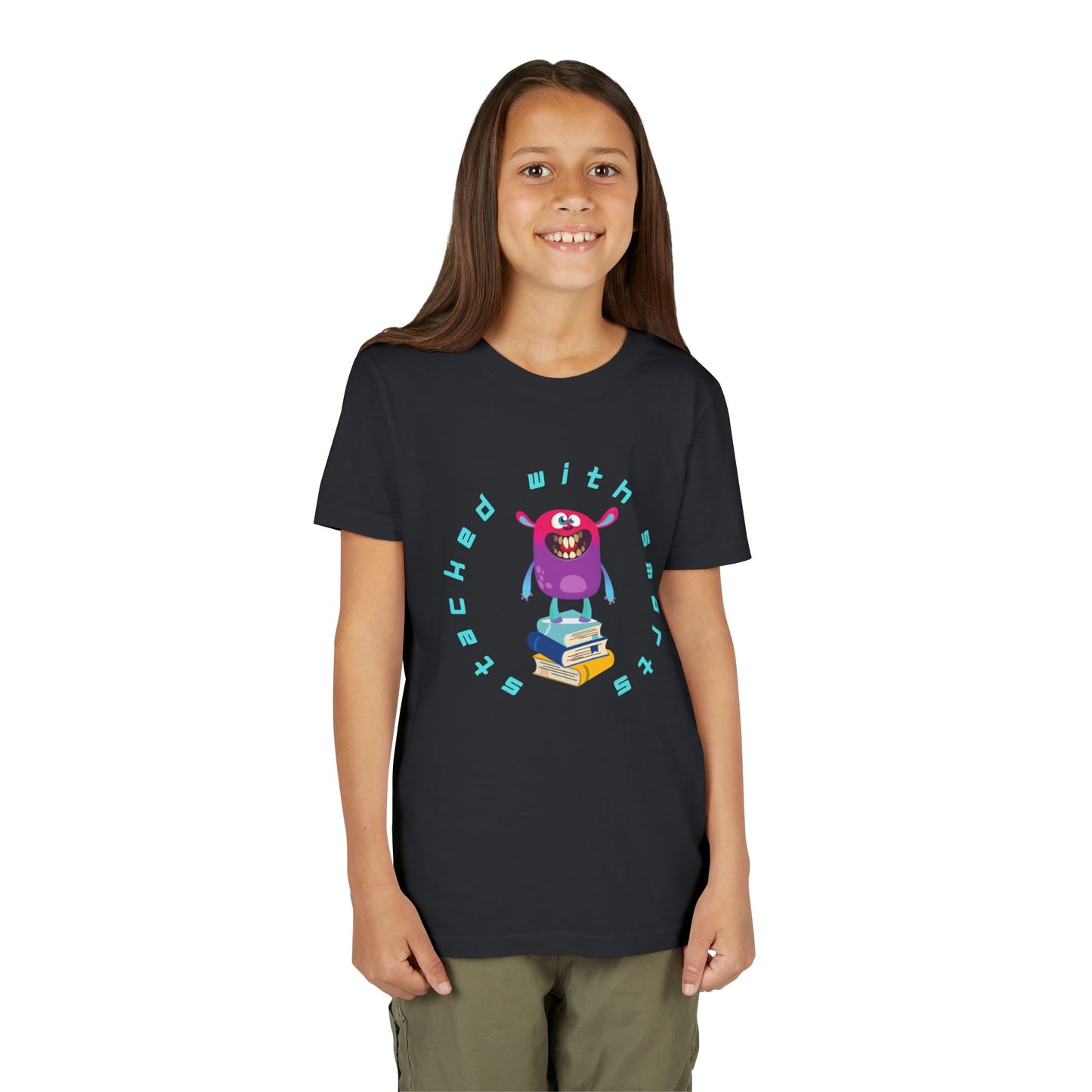 Girl wearing a black t-shirt with a colorful, toothy monster graphic standing on a stack of books, circled by text 'STACKED WITH SMARTS'
