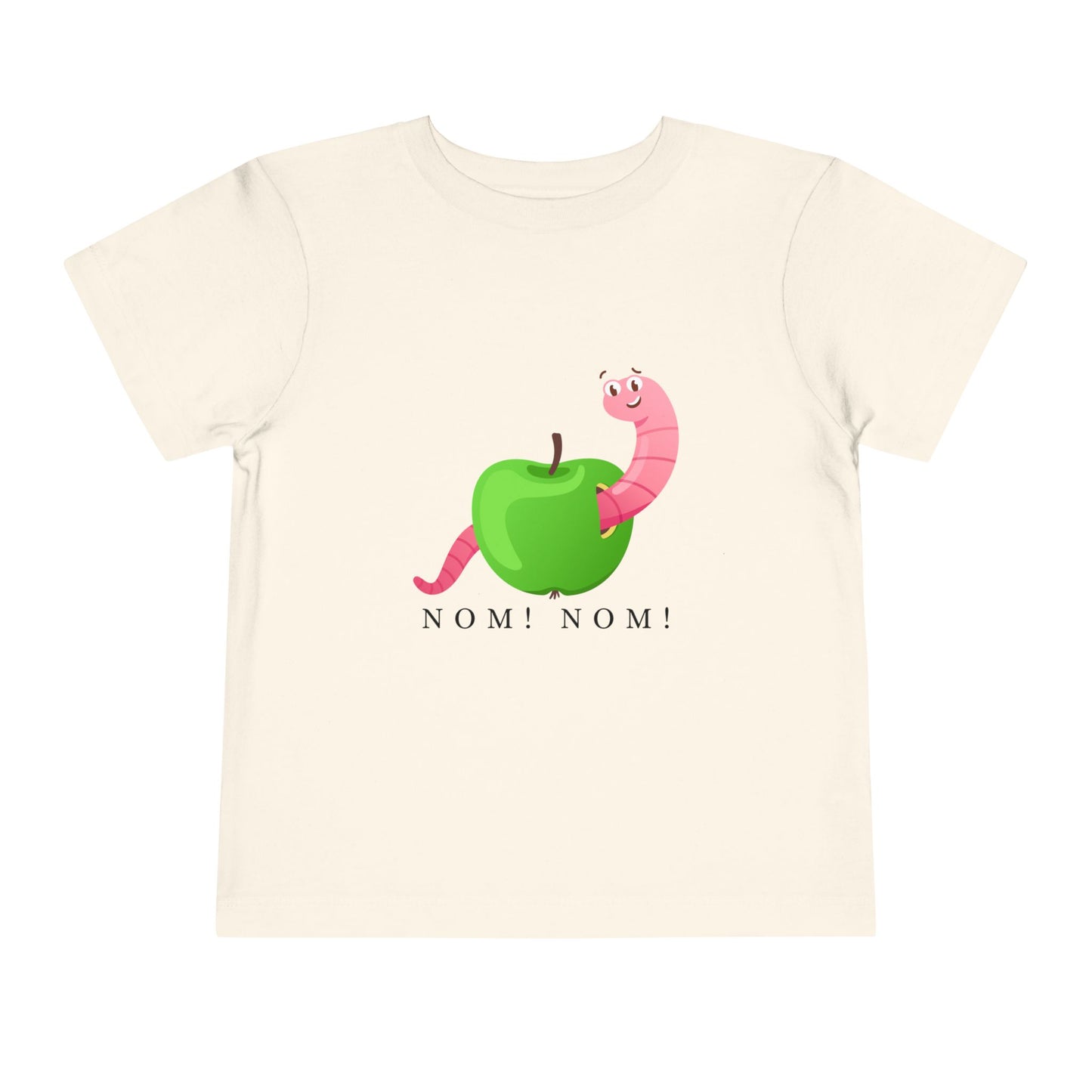 Beige toddler t-shirt with a green apple and pink worm graphic and 'NOM! NOM!' text 