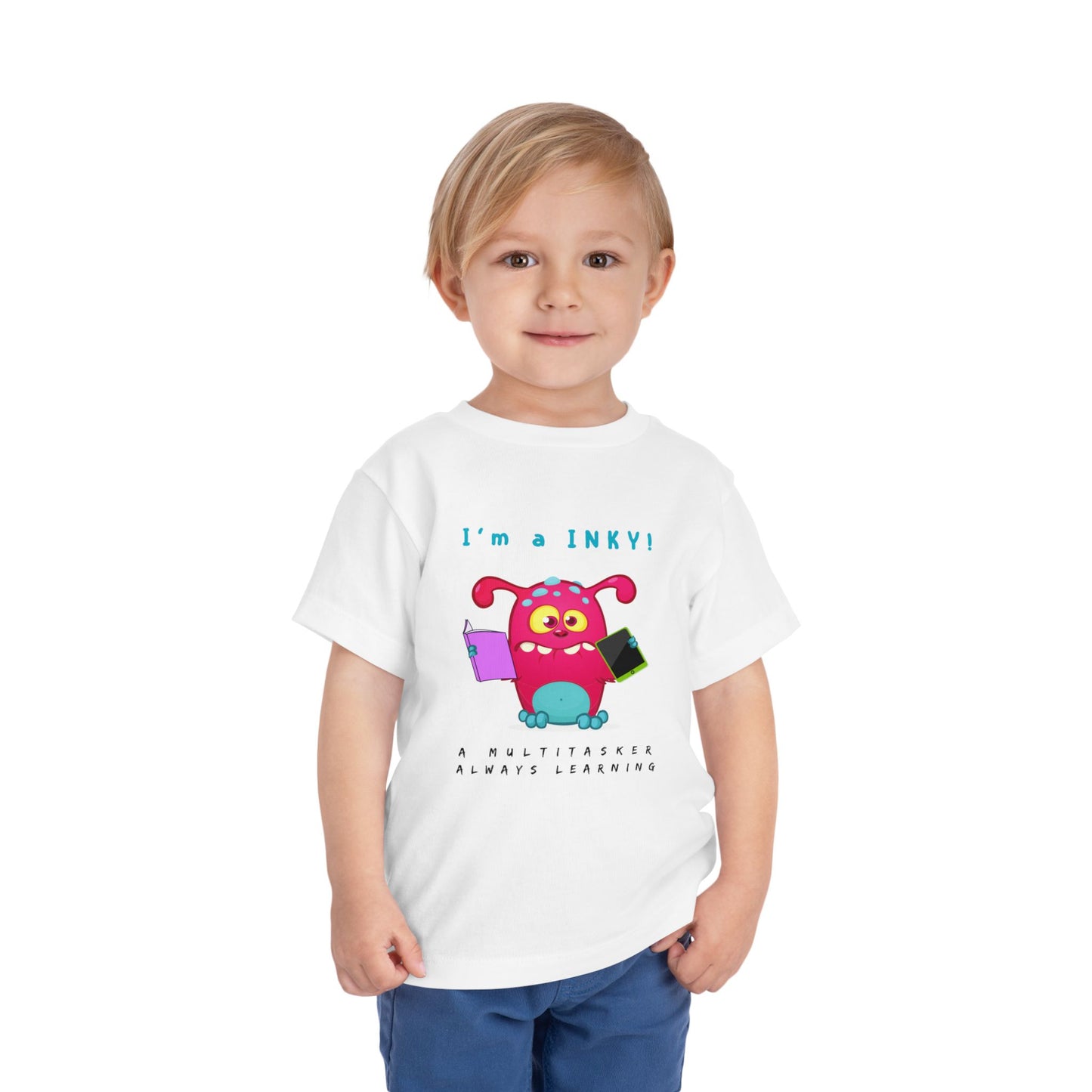 Child wearing a white toddler personality t-shirt with a colorful cartoon monster holding a book and i-pad while proudly proclaiming 'I'm A Inky!' Sub-text "A Multitasker, Always Learning' on a white background