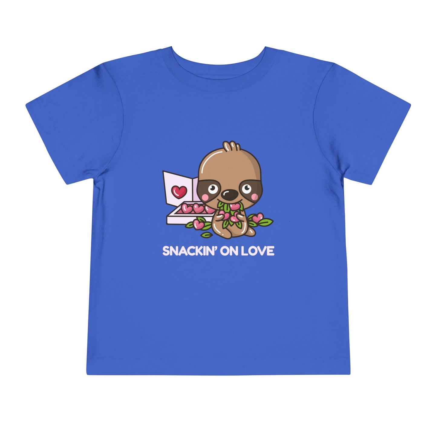 Blue toddler t-shirt with a cartoon eating a box of heart shaped candies, text 'SNACKIN' ON LOVE'