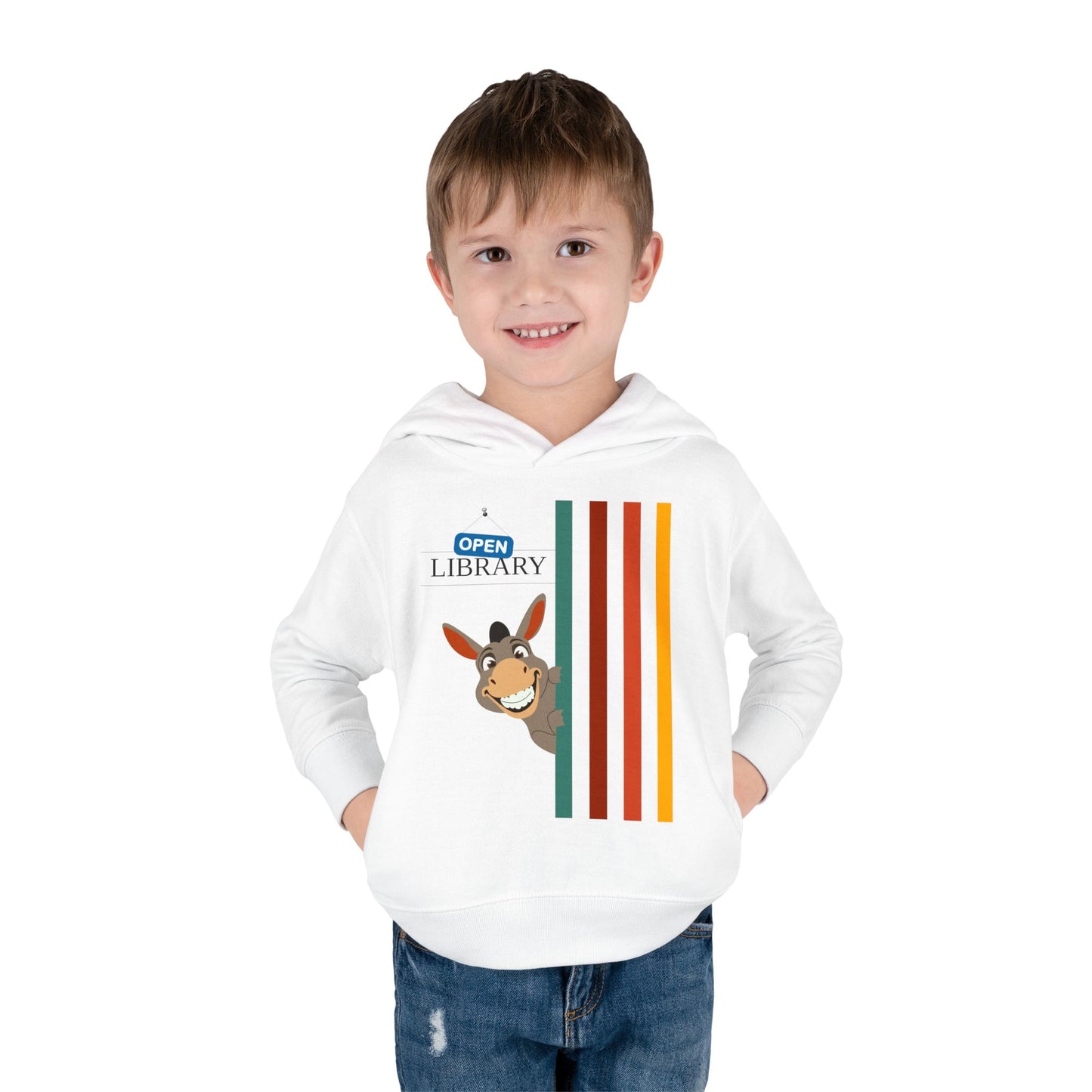 Boy wearing a white toddler hoodie with a cartoon donkey peaking around a wall of rainbow strips and 'Open Library' signage