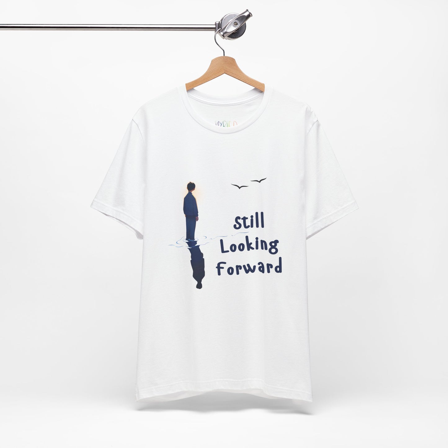 White t-shirt with graphic of a person standing in the water with his reflection and text 'Still Looking Forward' 