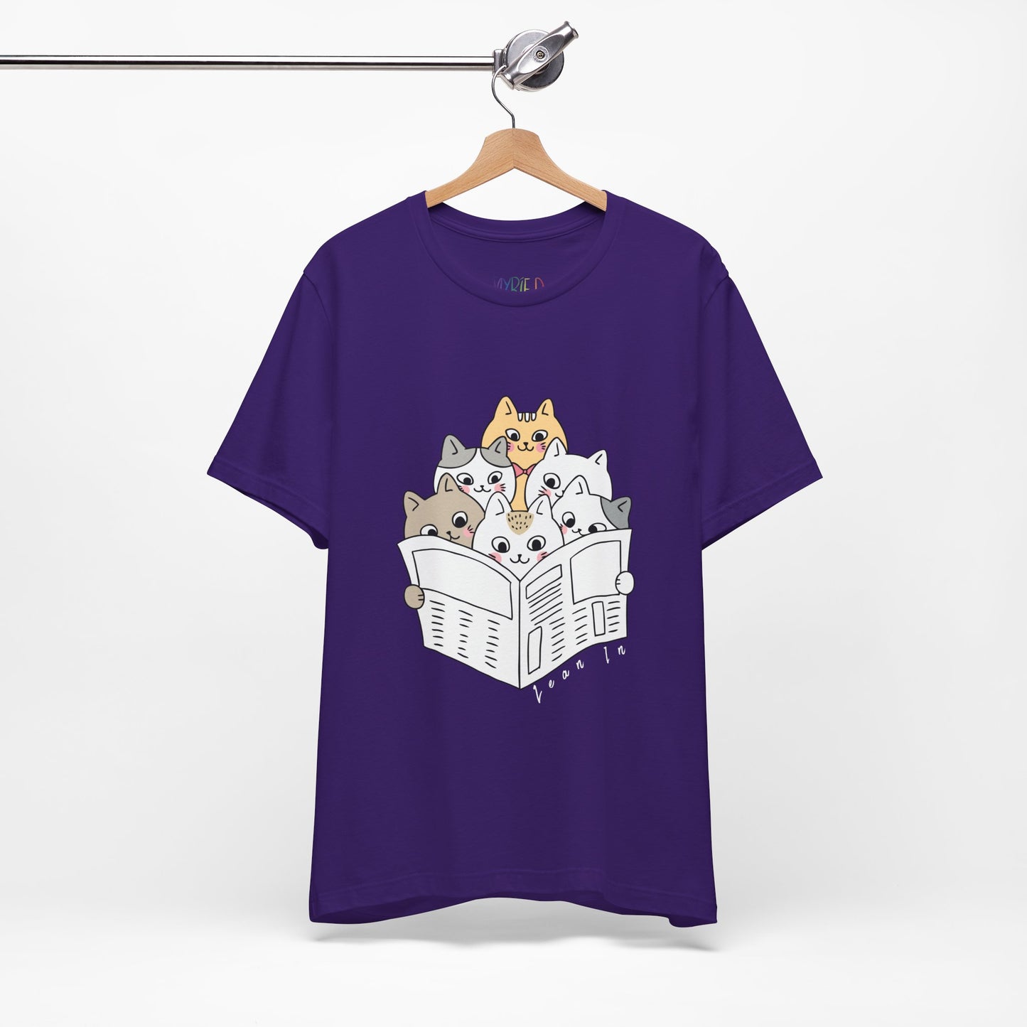 Purple t-shirt with cartoon cats squeezed in to read the newspaper and text 'Lean In'