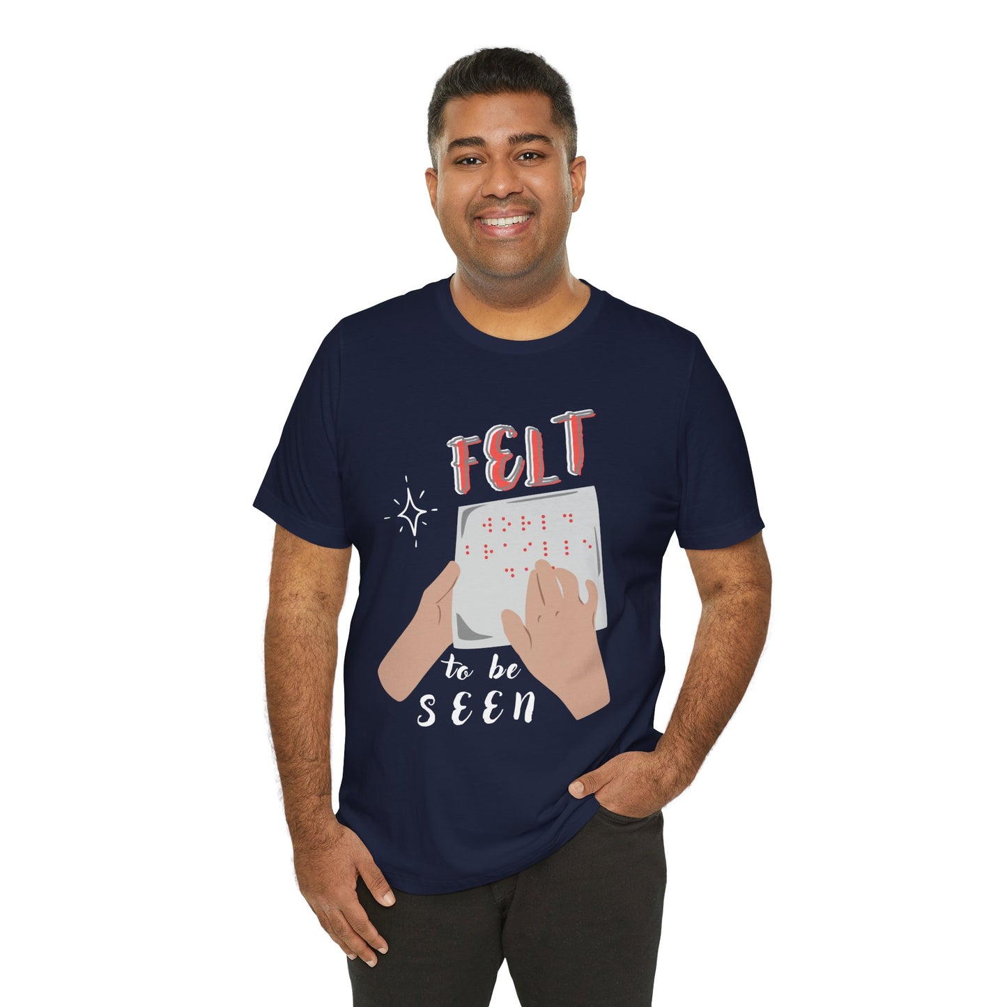 Man wearing a navy blue t-shirt with graphic design of hands reading braille text and 'Felt To Be Seen' messaging 