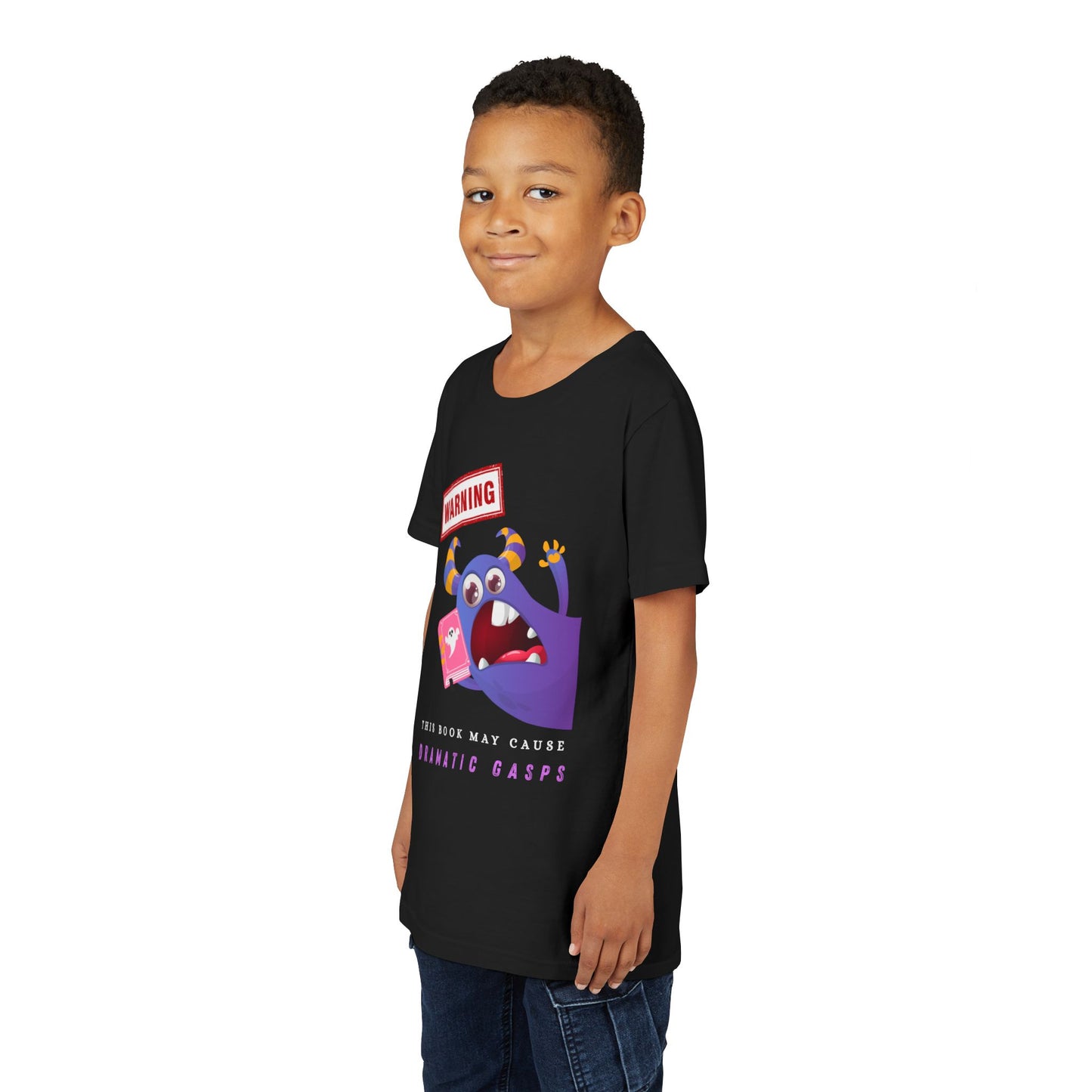 Boy wearing a black t-shirt with a purple monster urgently leaning in with a ghost book, a WARNING sign overhead, and text below 'This Book May Cause Dramatic Gasps'