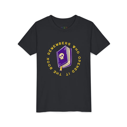 Black t-shirt with a purple book graphic, featuring a skull on the cover and surrounded by yellow text 'The Book Remembers Who Opened It'
