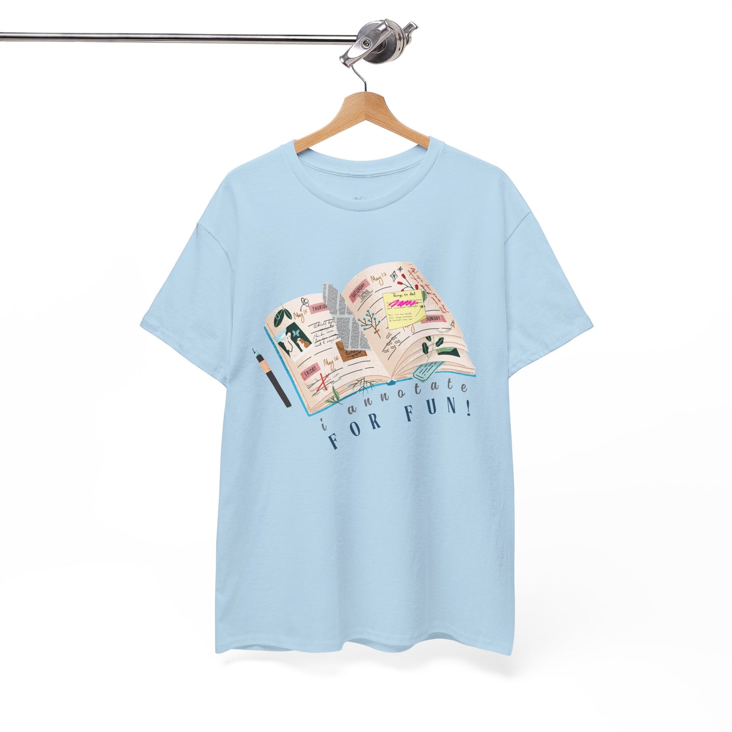 Light blue t-shirt with a An open scrapbook full of scribbles, tickets, newspaper clippings and more, text 'I Annotate For Fun' 