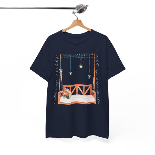 Navy blue t-shirt with a porch swing, string lights, hot beverage and a stack of books, text says 'Sitting Pretty With My Paperbacks'