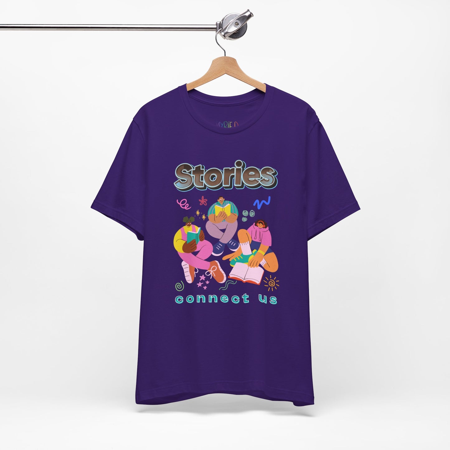Purple t-shirt with colorful modern people reading, surrounded by doodles, and text 'Stories connect us' 