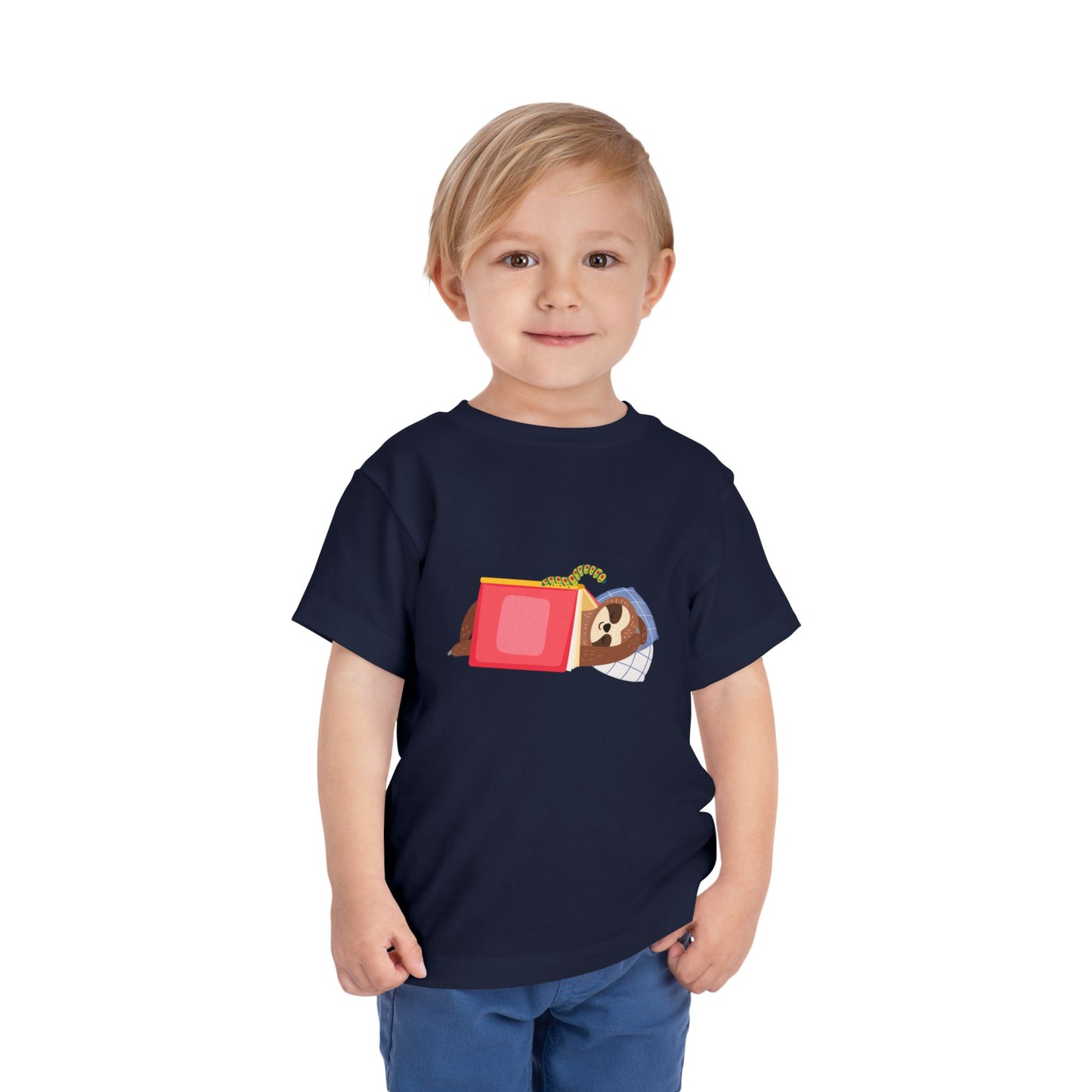 Child wearing a navy blue toddler t-shirt featuring a book work looking at a sleeping sloth under a book