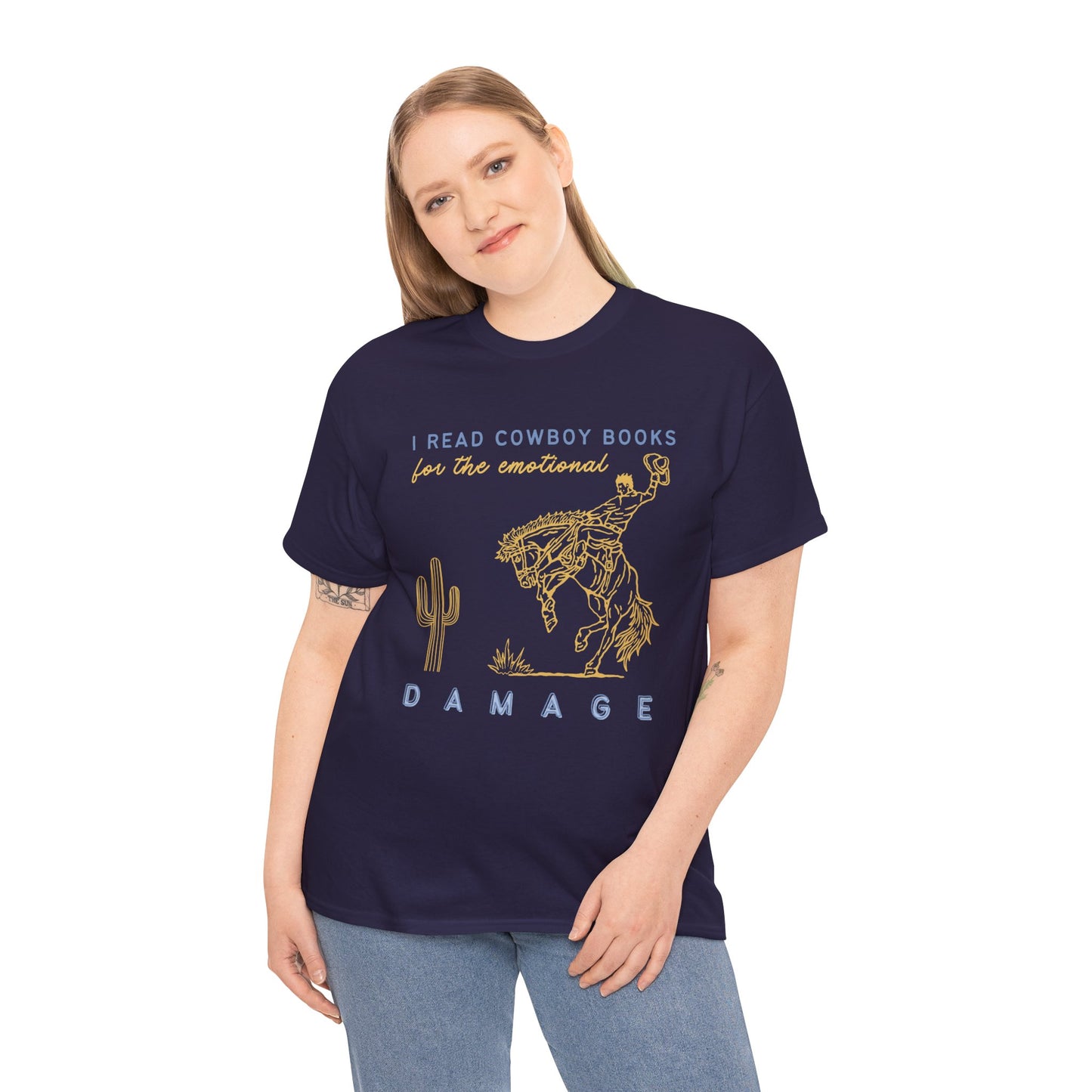 Woman wearing a dark blue t-shirt with gold bucking bronco cowboy graphic and text 'I Read Cowboy Books For The Emotional Damage' 