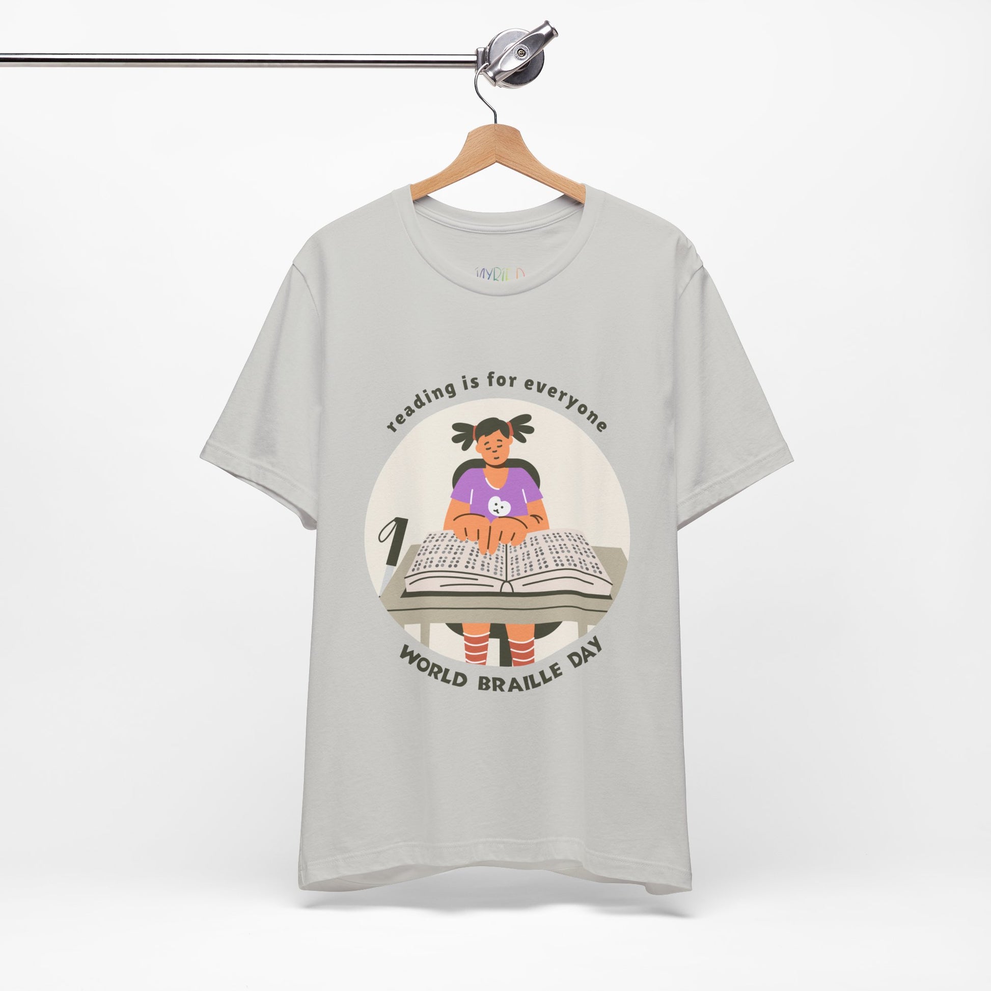 Gray t-shirt with a girl reading a book in braille and text circling that says 'Reading Is For Everyone, World Braille Day' 
