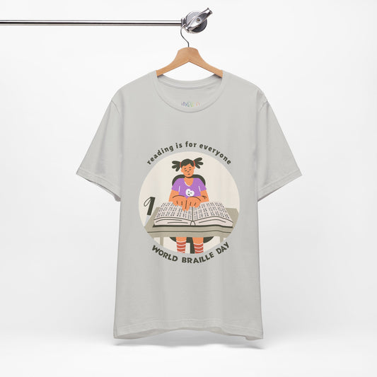Gray t-shirt with a girl reading a book in braille and text circling that says 'Reading Is For Everyone, World Braille Day' 