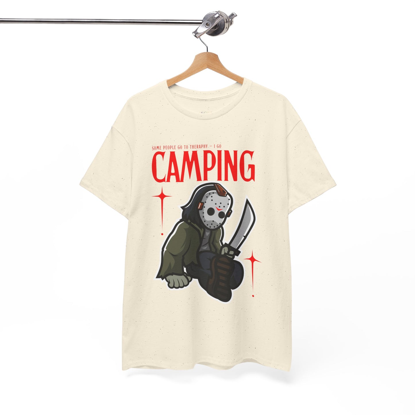 Beige t-shirt with a graphic design of a Jason character holding a knife and text 'Some People Go to Therapy...I Go CAMPING' on a hanger against a white background.