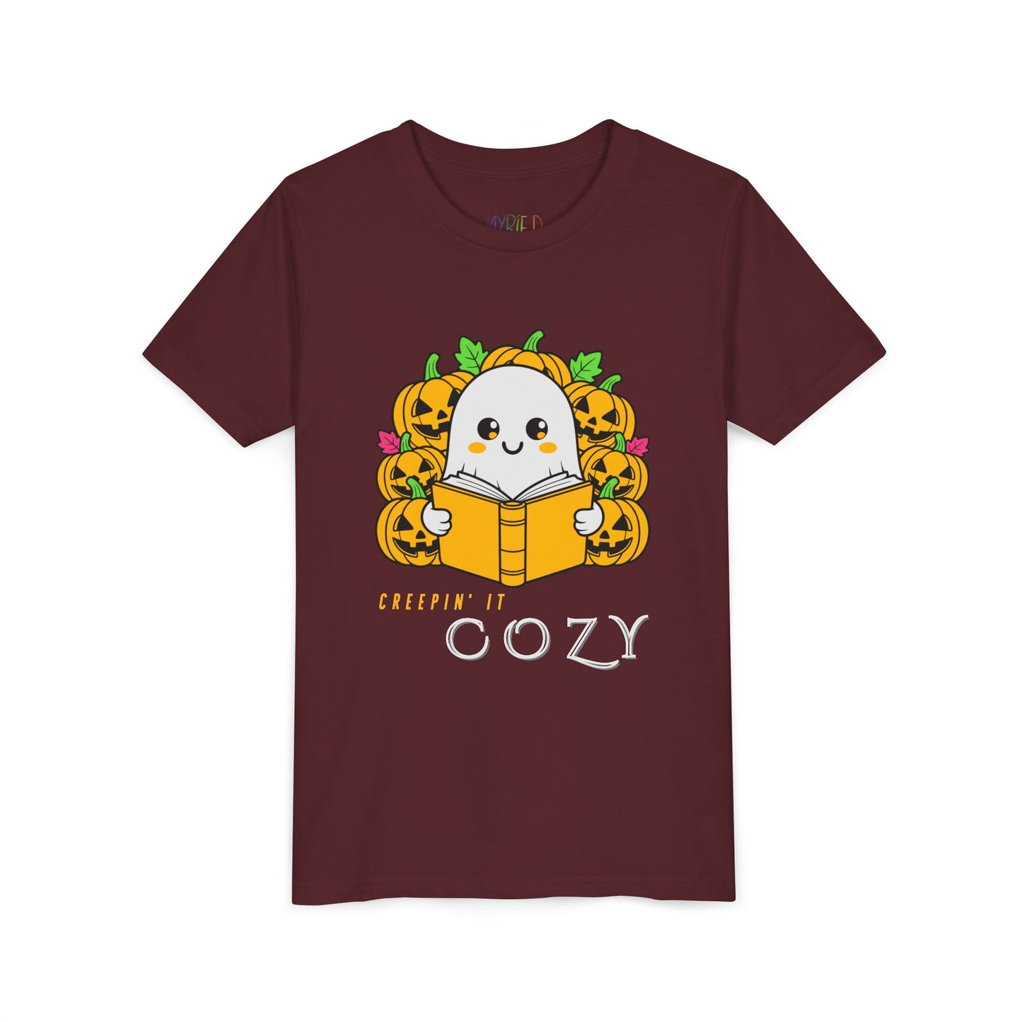 Maroon t-shirt with a ghost reading a book in a pumpkin patch with text 'Creepin' It Cozy'