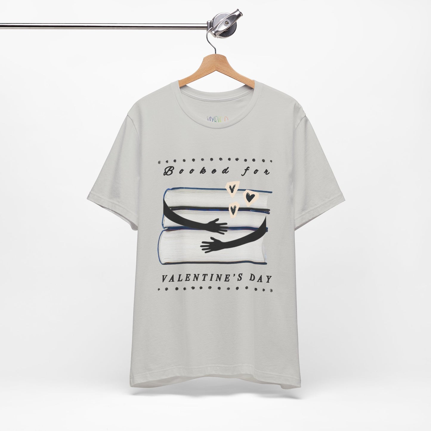 Silver t-shirt with a graphic design featuring arms hugging a stack of books and text 'Booked for Valentine's Day' 