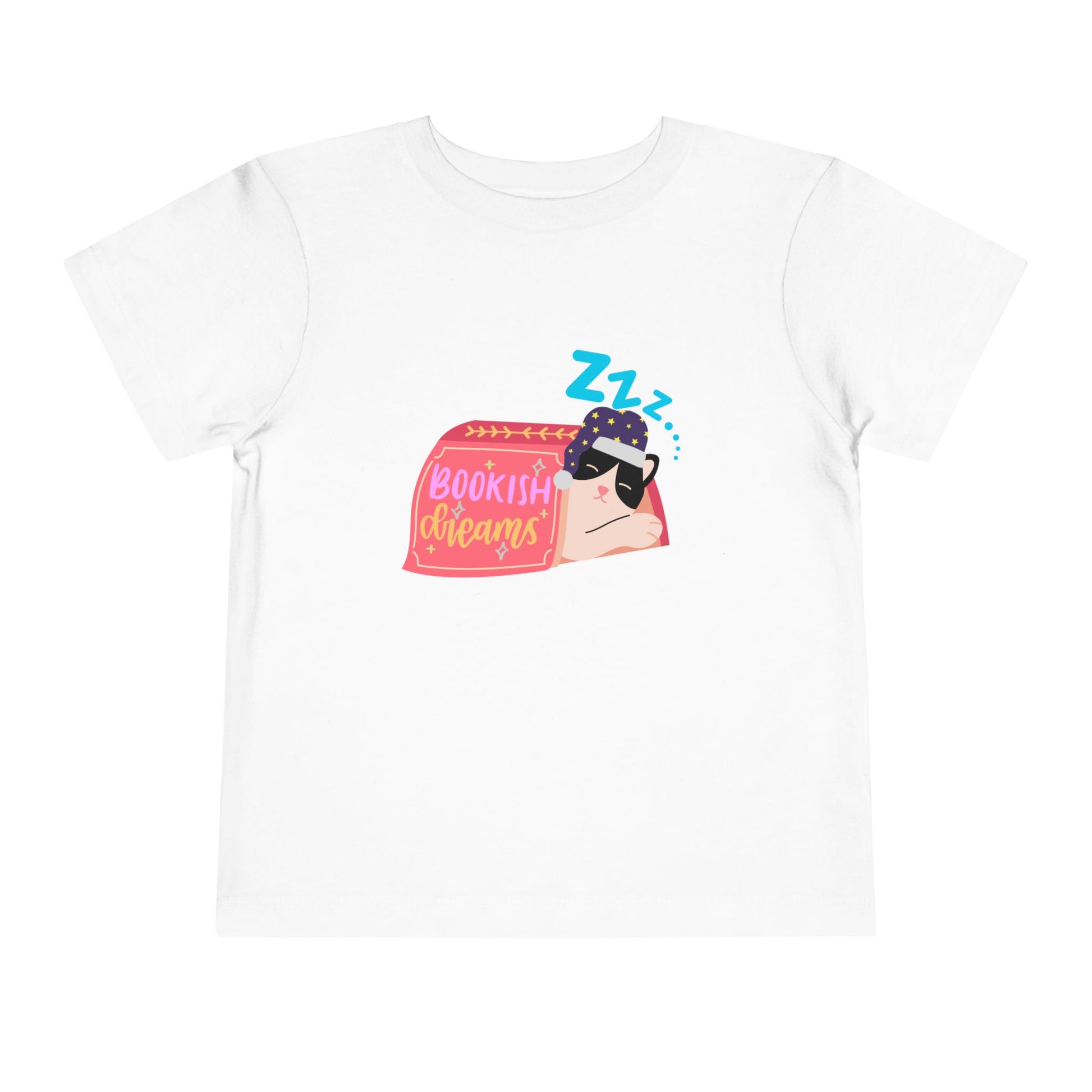 White toddler t-shirt with a snoozing cat in a night cap, under a book and text 'Bookish Dreams' 