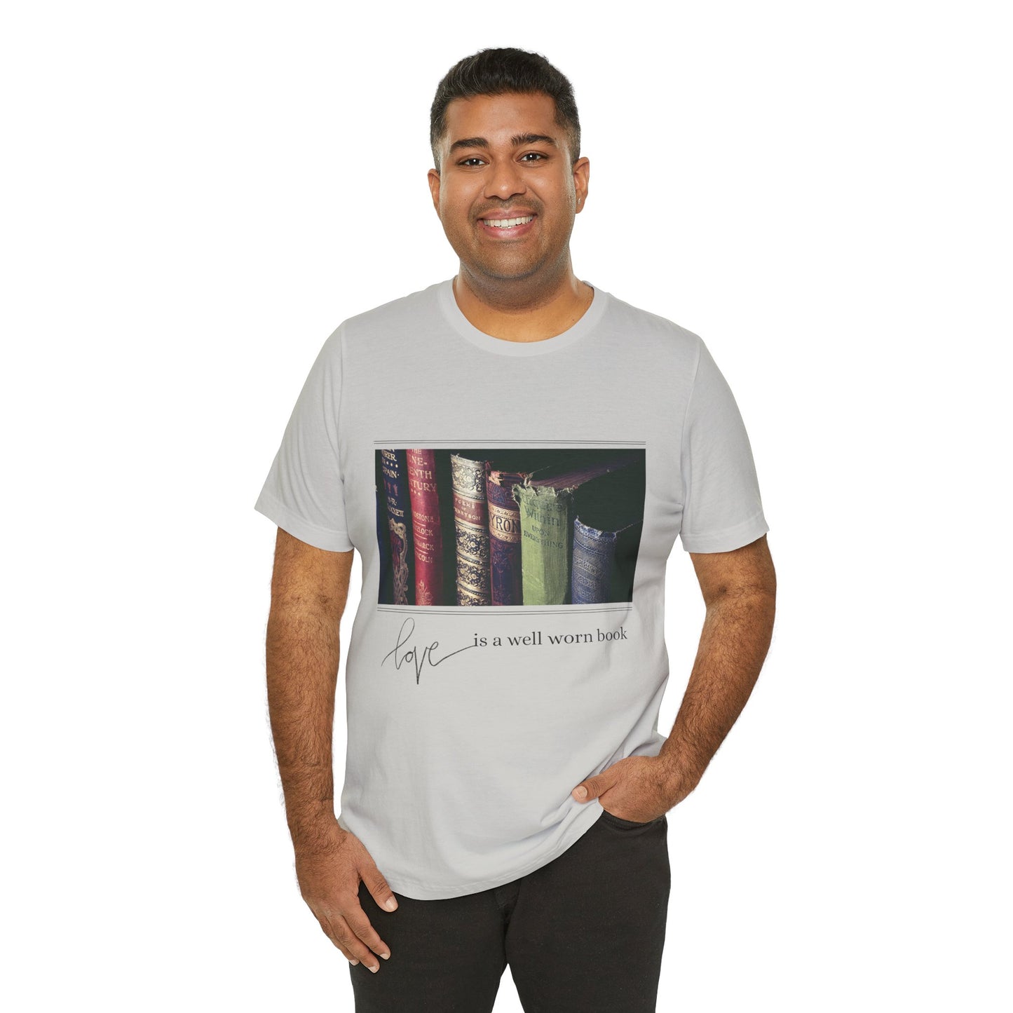 Man wearing a gray t-shirt with a row of old books and text 'Love Is A Well Worn Book'