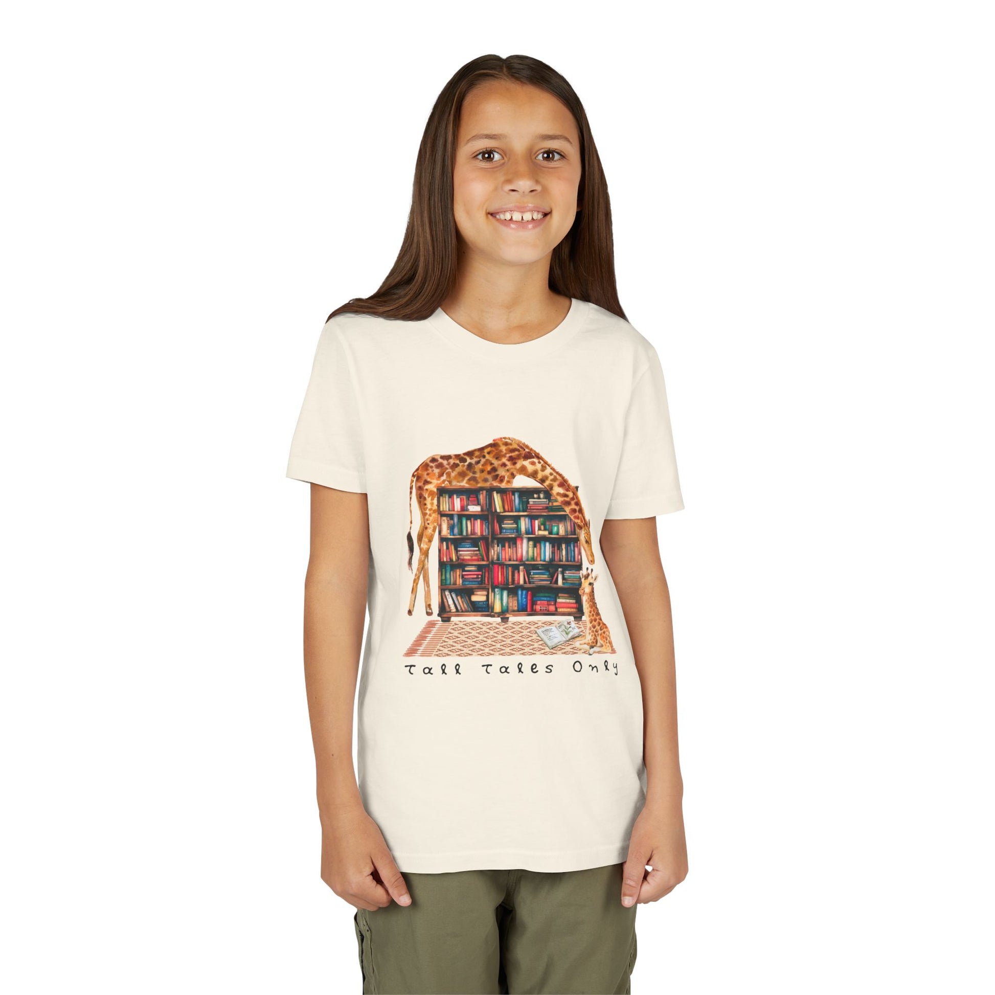 Girl wearing a beige t-shirt with a graphic of giraffes in a library and 'Talk Tales Only' text 
