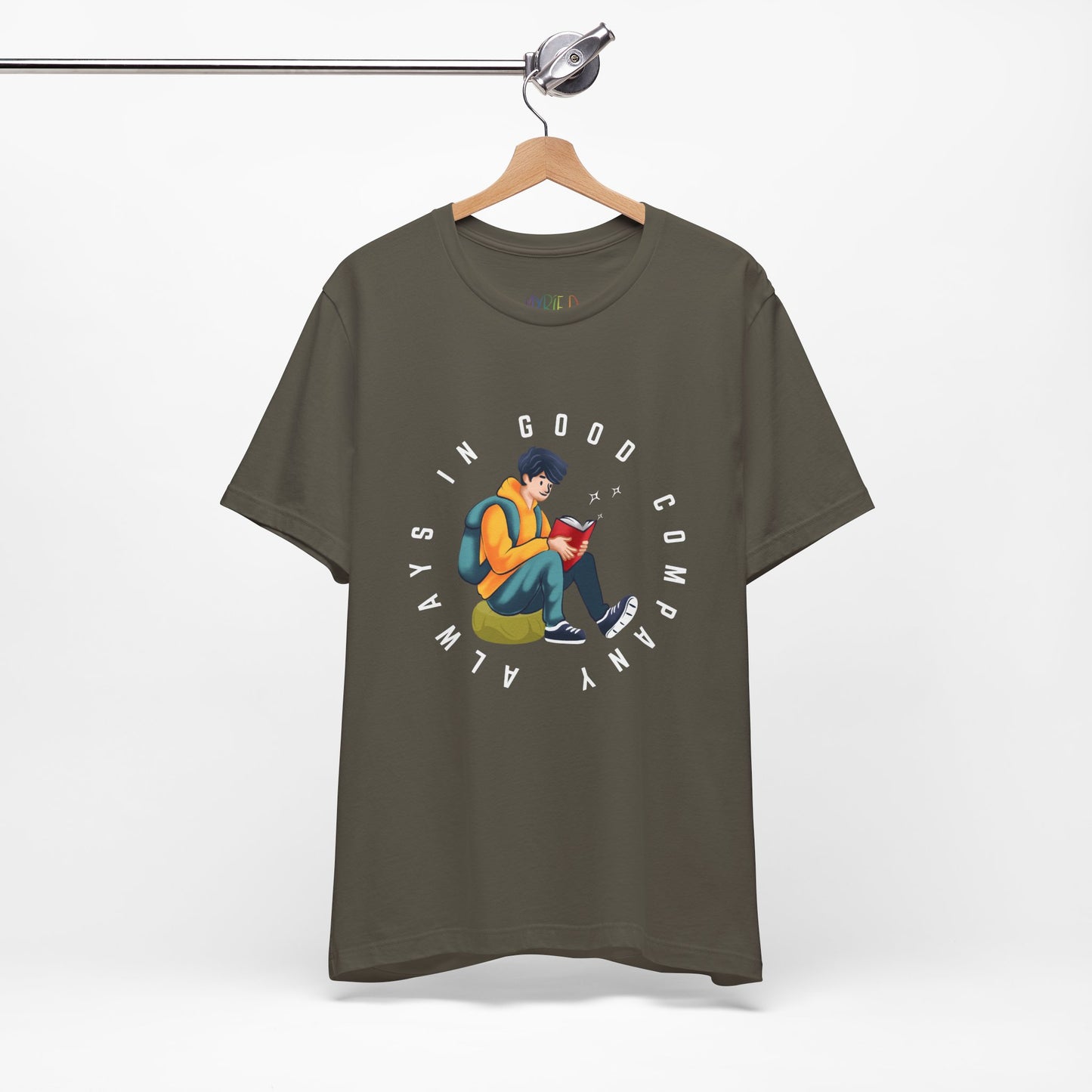 Army green t-shirt with a graphic design of a person reading a book, sitting on a green bag, with text 'Always In Good Company' 