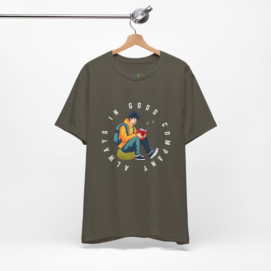 Army green t-shirt with a graphic design of a person reading a book, sitting on a green bag, with text 'Always In Good Company' 