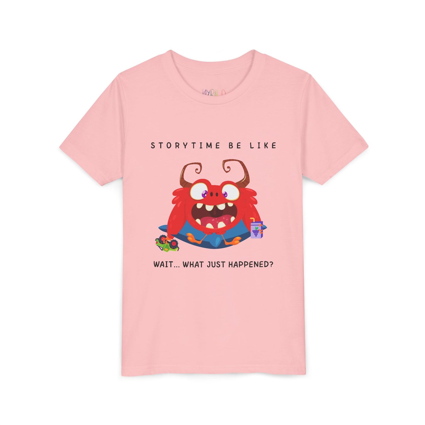 Pink t-shirt with a bewildered cartoon monster graphic sitting on a pillow, holding a car toy and a juice box, text 'Storytime be like wait...what just happened?'