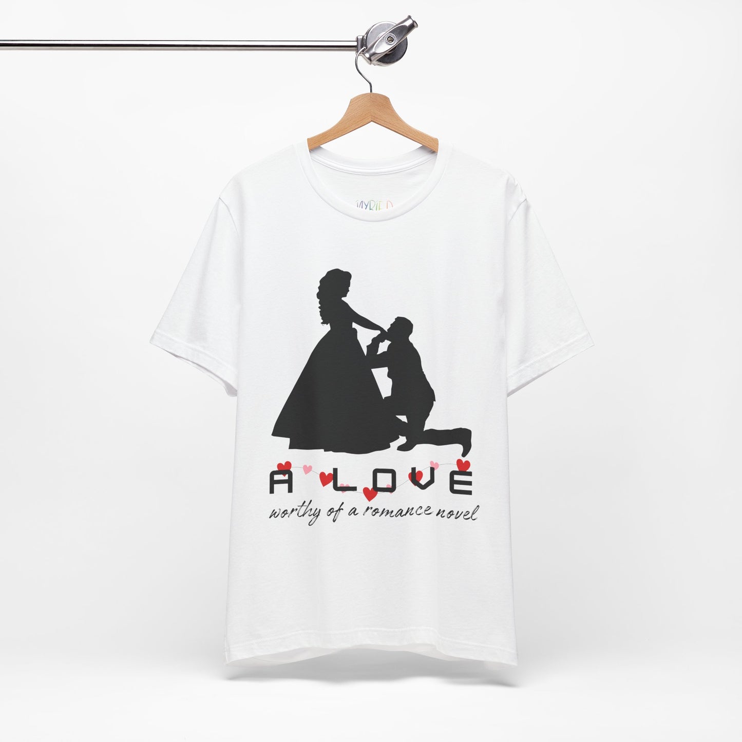 White t-shirt with black graphic if a man kneeling in front of a woman in a gown and text 'A LOVE worthy of a romance novel'