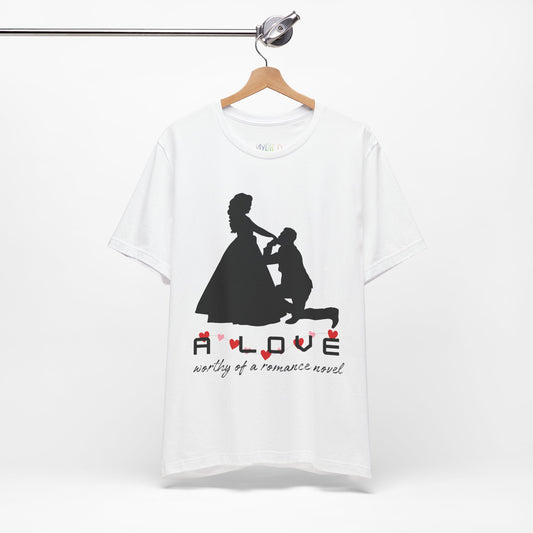 White t-shirt with black graphic if a man kneeling in front of a woman in a gown and text 'A LOVE worthy of a romance novel'