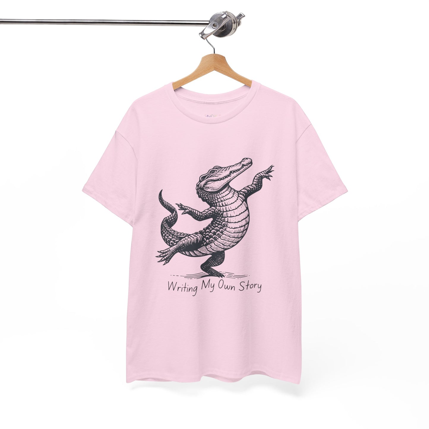 Pink t-shirt with dancing alligator graphic and text 'Writing My Own Story' 