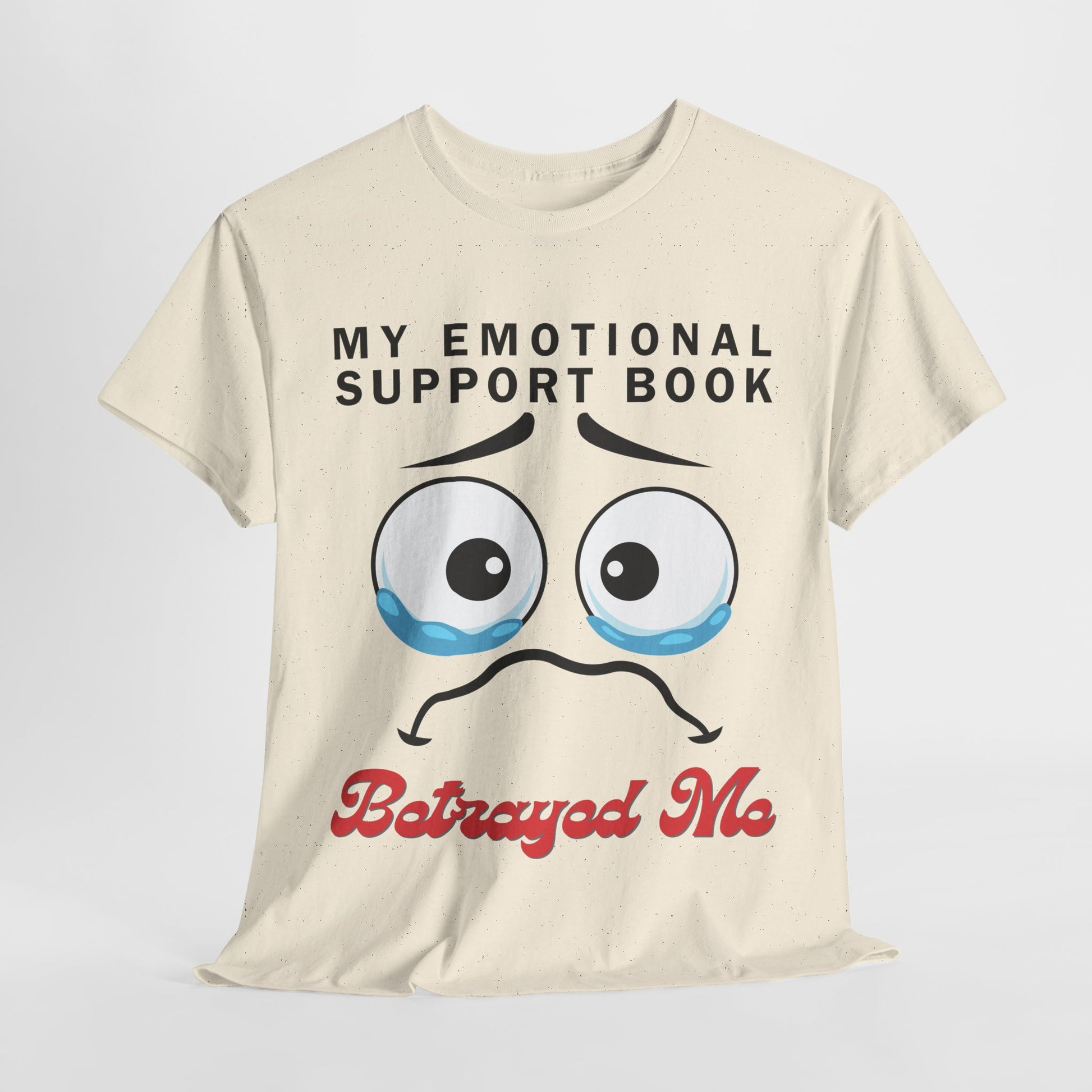 Beige t-shirt with tearful eyes, a furrowed brow and quivering sad mouth, text 'My Emotional Support Book Betrayed Me'