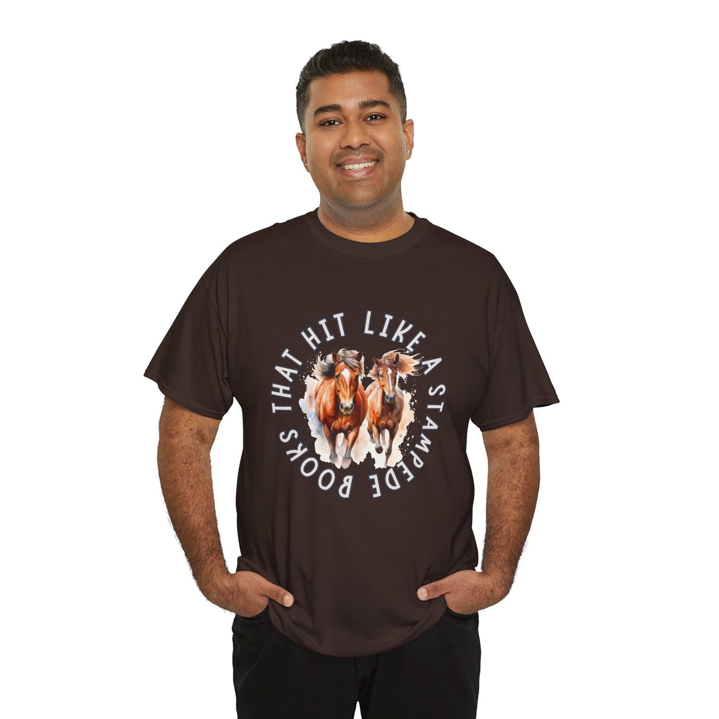Man wearing a brown t-shirt with horses running out from the center of the shirt and circled by words 'Books That Hit Like a Stampede' 