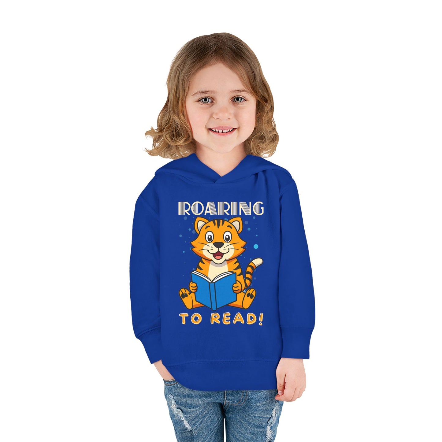 Girl wearing a blue toddler hoodie with a tiger reading a book and text 'ROARING TO READ!'