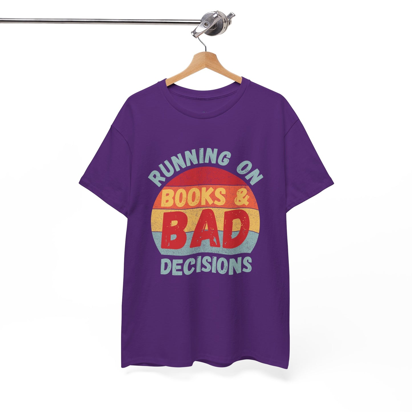 Purple t-shirt with colorful retro striped sunset and text 'Running On Books & Bad Decisions' 