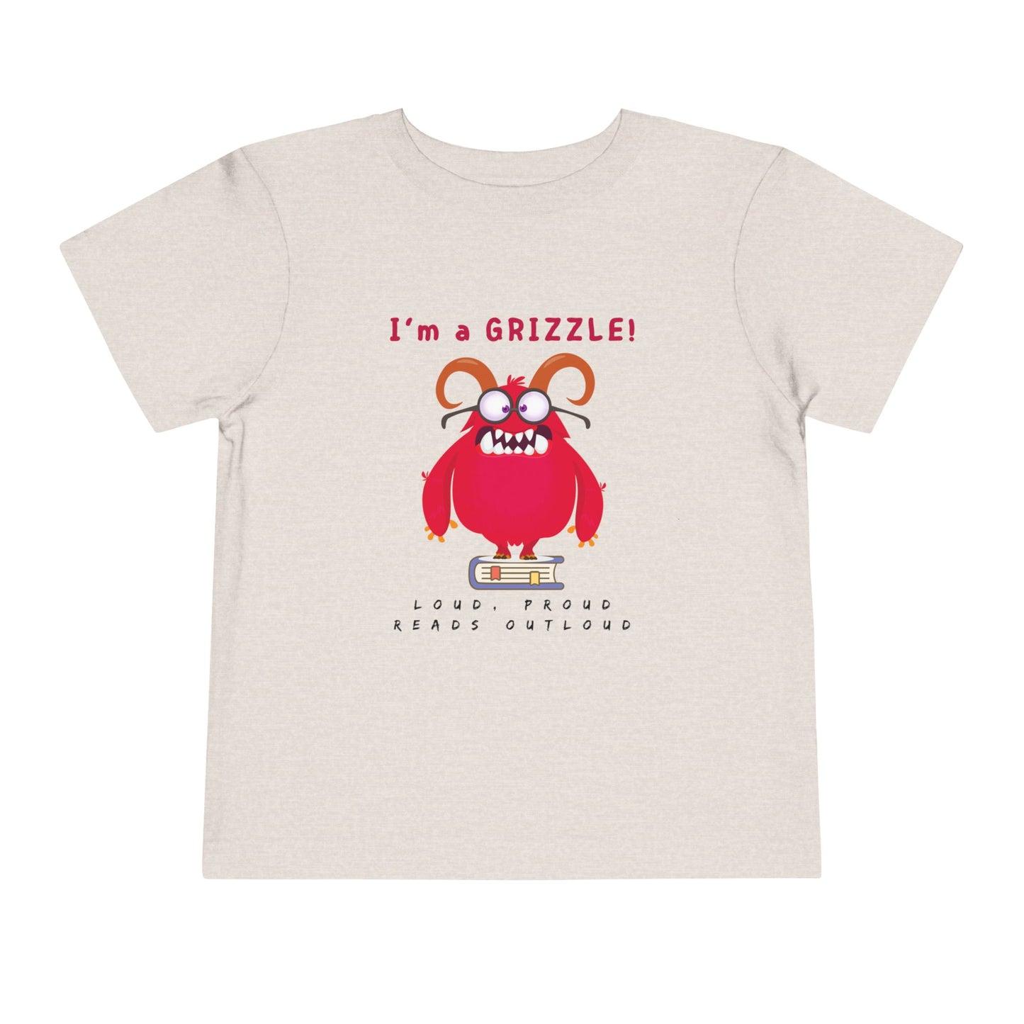 Gray/tan toddler personality t-shirt with a red monster graphic standing on a book proudly proclaiming 'I'm a GRIZZLE!' Sub-text 'Loud, Proud, Reads Aloud.'