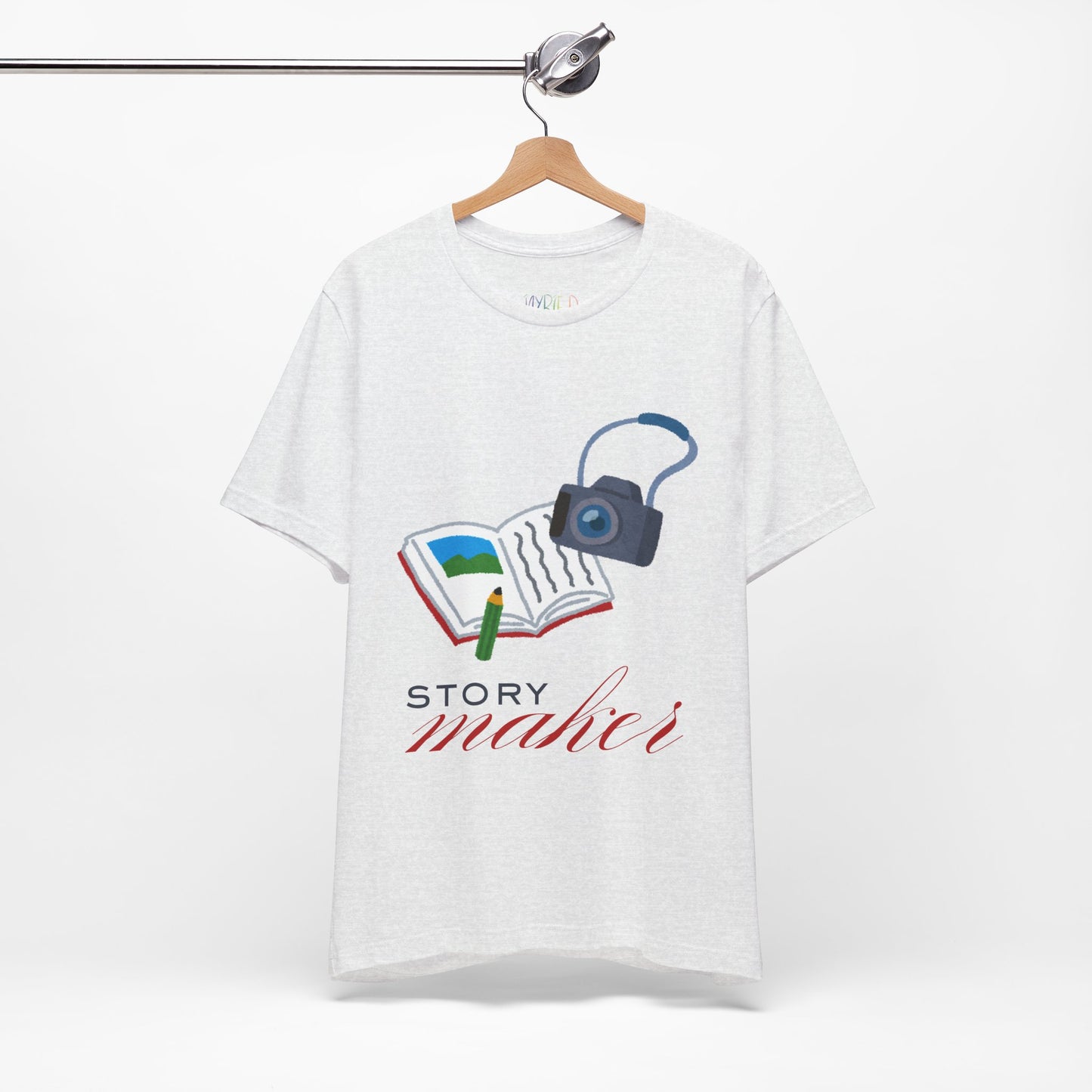 Light ash gray t-shirt with an open book, pencil and camera, 'Story Maker' text beneath