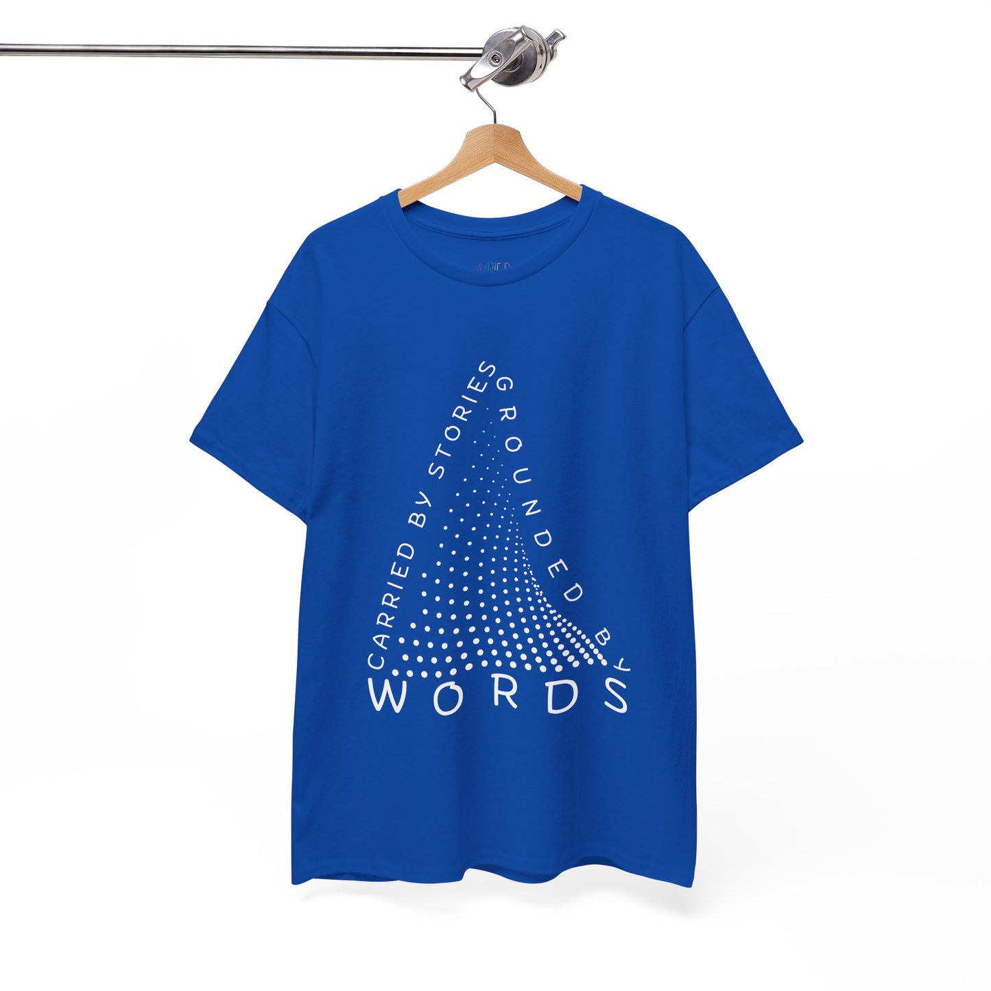 Blue t-shirt with white text that follow the outline of a dotted triangle 'Carried By Stories, Grounded By Words' 