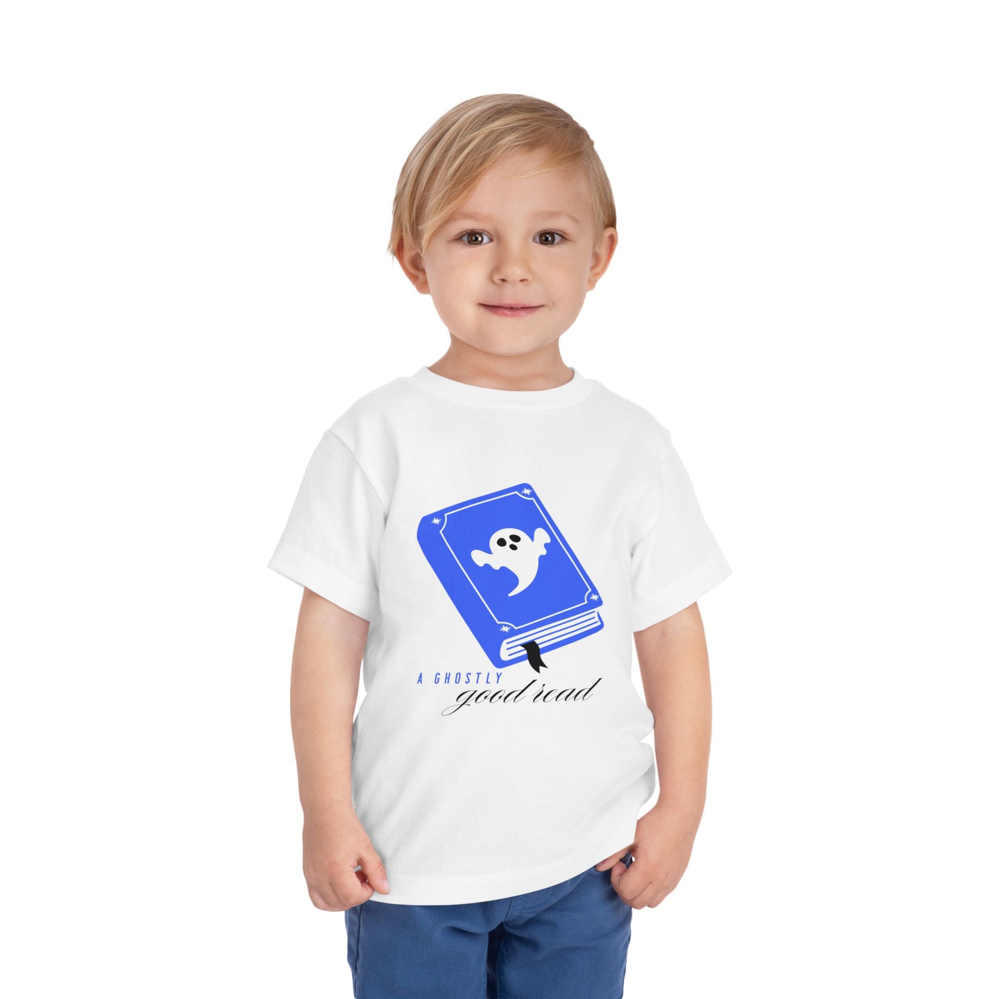 Toddler wearing a white t-shirt with blue book with a ghost on the cover and text 'A ghostly good read' 
